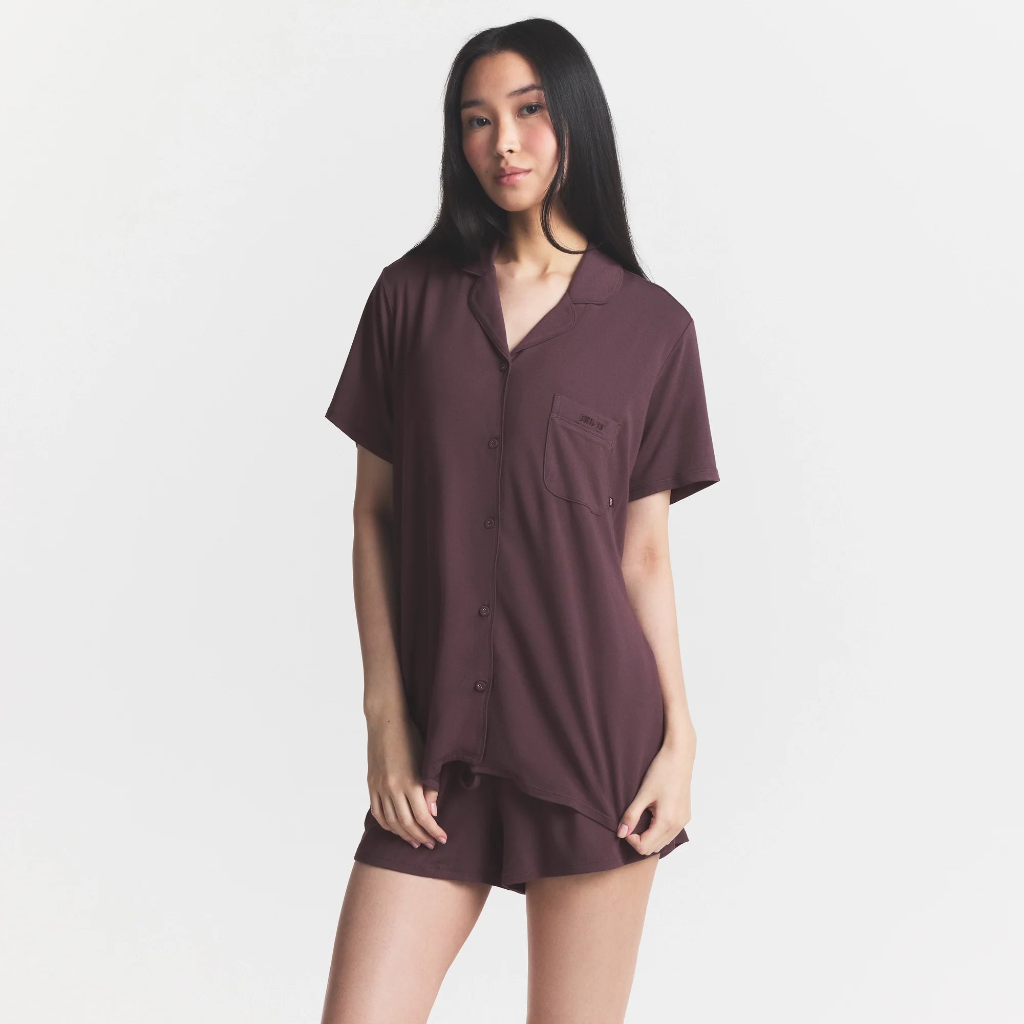 SKIMS SLEEP SHORT SLEEVE BUTTON UP SET | RAISIN ON A MODEL SIDE VIEW @ | FOCUS: 0.0, 1.0, 0.9