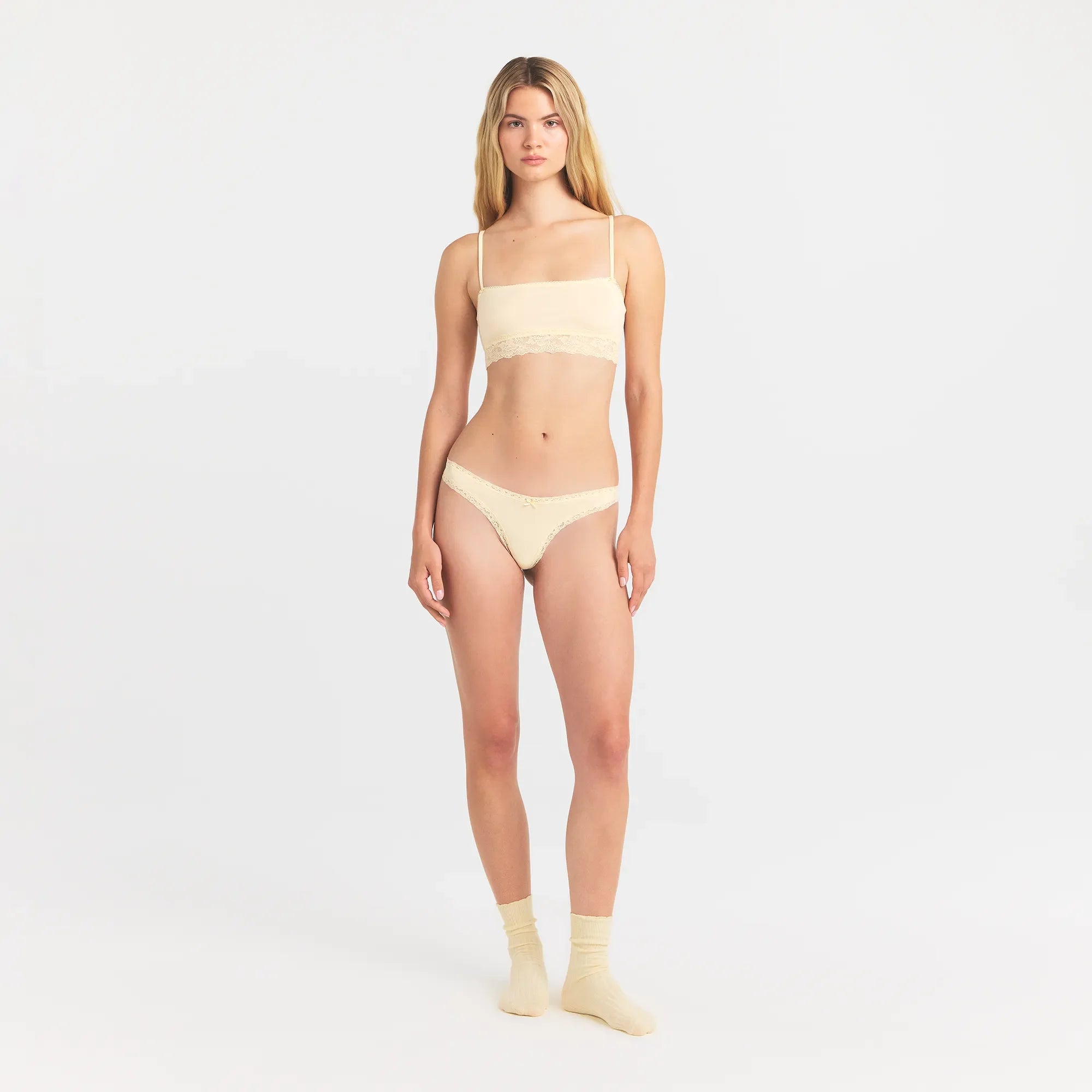 LIGHTWEIGHT COTTON LACE THONG | BUTTER TONAL ON A MODEL FRONT VIEW @ | FOCUS: 0.0, 1.0, 0.9