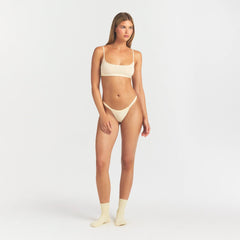 LIGHTWEIGHT COTTON LOGO PICOT THONG | BUTTER TONAL ON A MODEL FRONT VIEW @ | FOCUS: 0.0, 1.0, 0.9