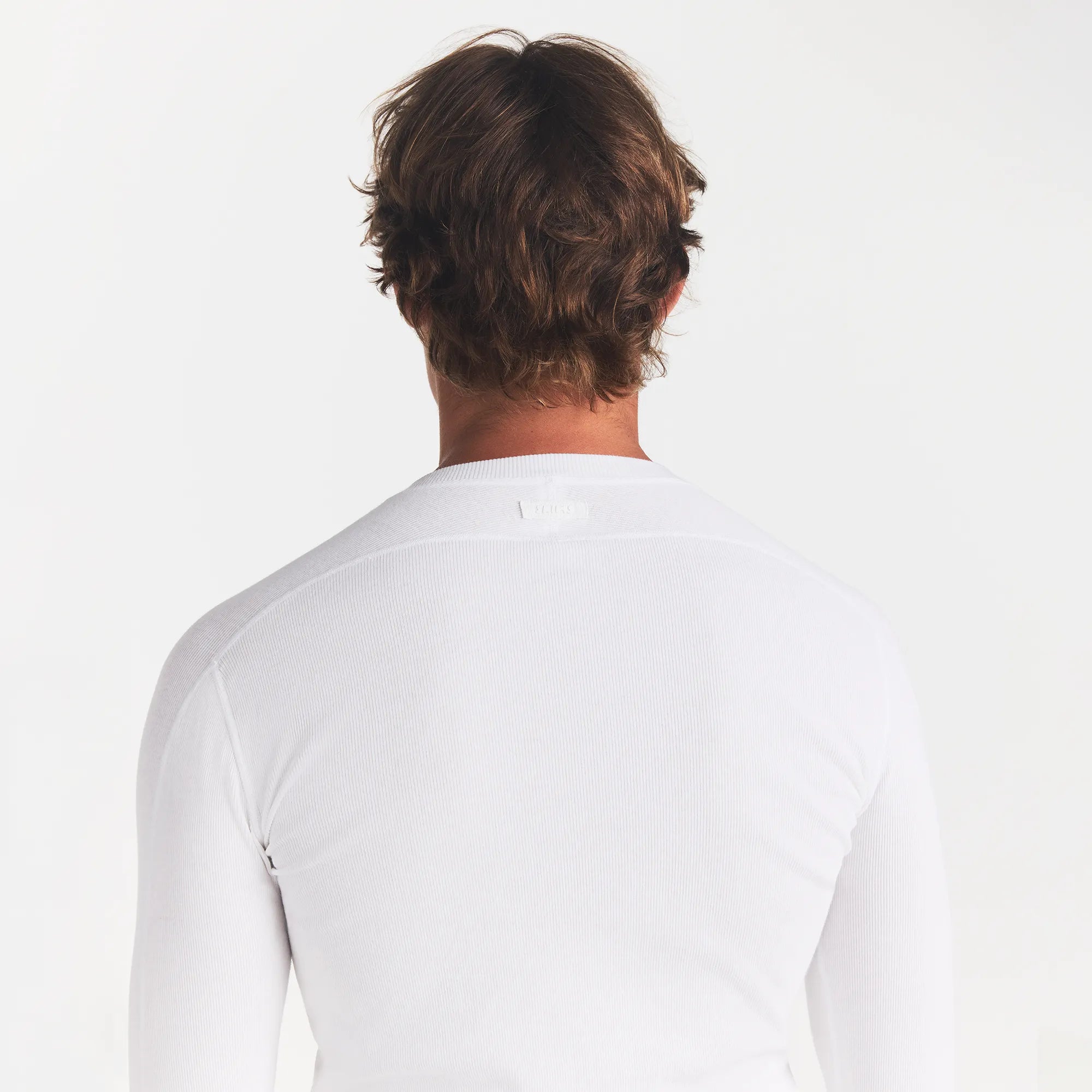 SKIMS COTTON RIB MENS HENLEY | CHALK ON A MODEL BACK VIEW @ | FOCUS: 0.0, 1.0, 0.9