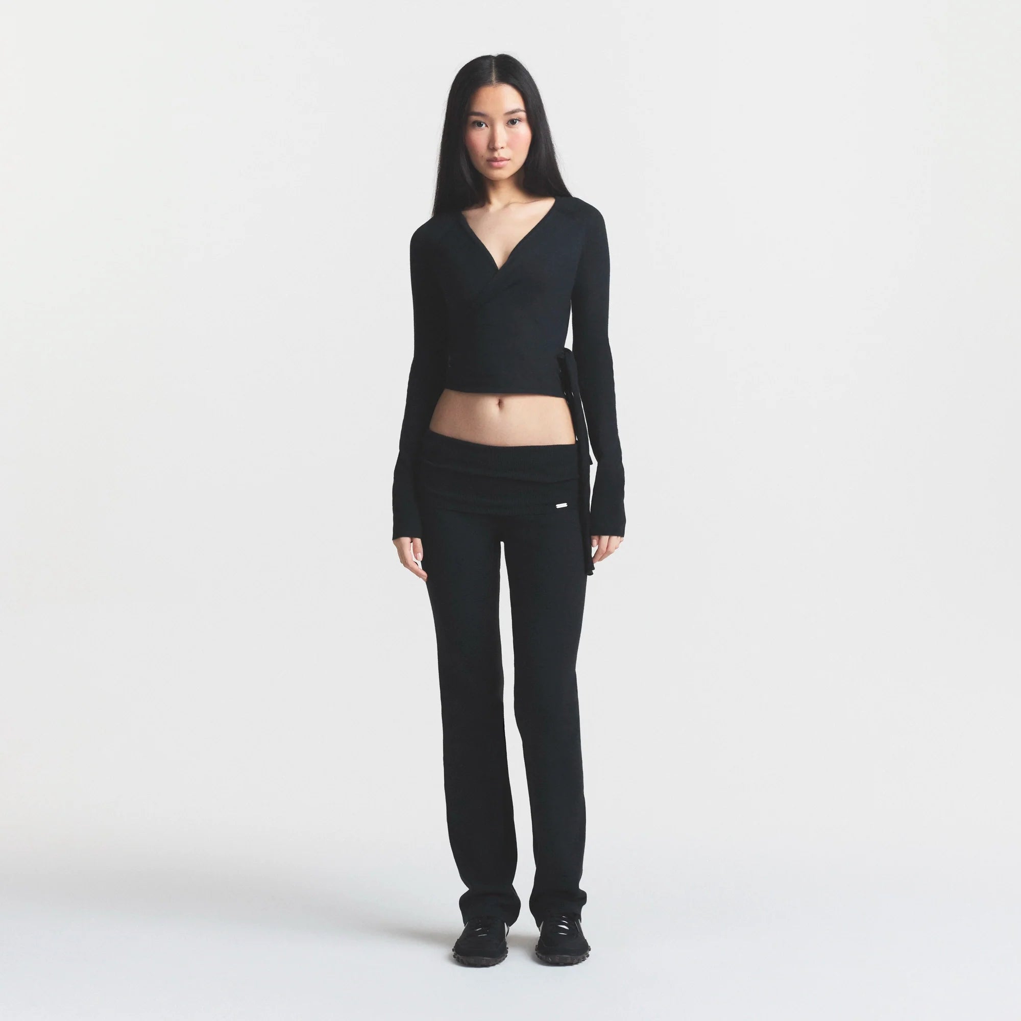 ESSENTIAL SWEATERS WRAP SWEATER | ONYX & LAYS FLAT ON A WHITE BACKGROUND | FLT @ | FOCUS: 0.0, 1.0, 0.9