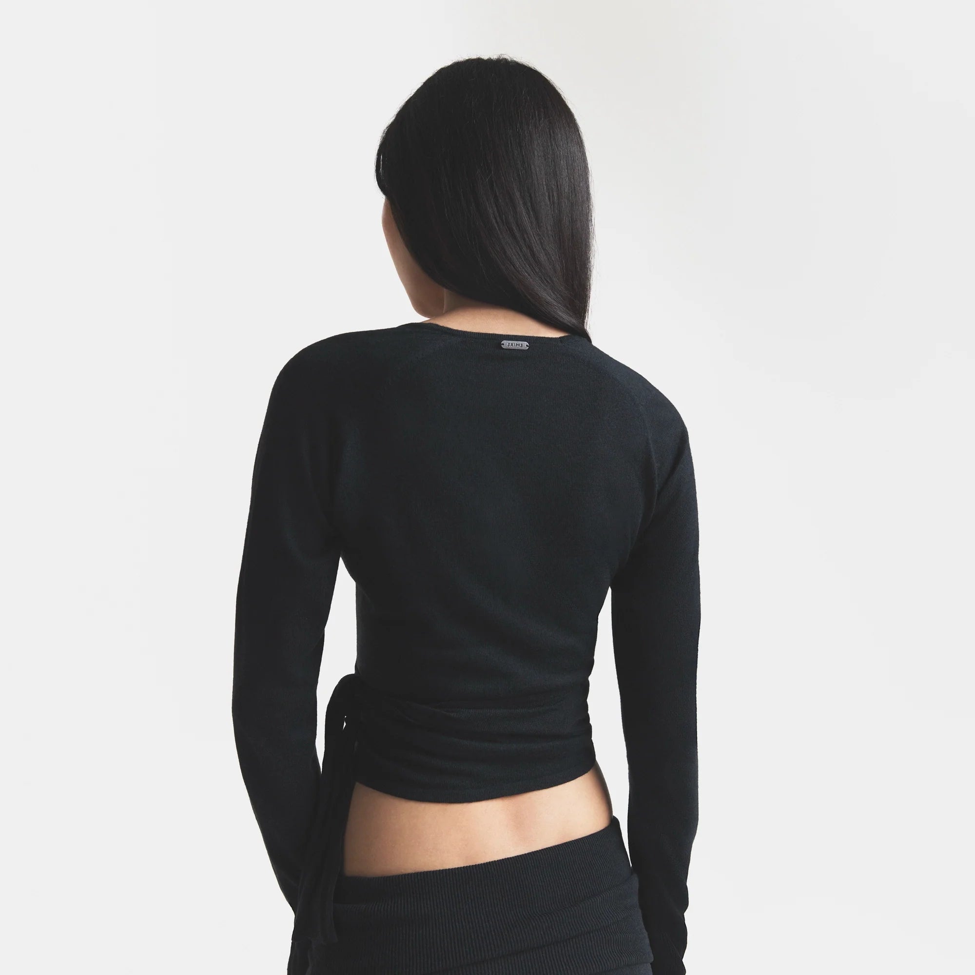ESSENTIAL SWEATERS WRAP SWEATER | ONYX & LAYS FLAT ON A WHITE BACKGROUND | FLT @ | FOCUS: 0.0, 1.0, 0.9