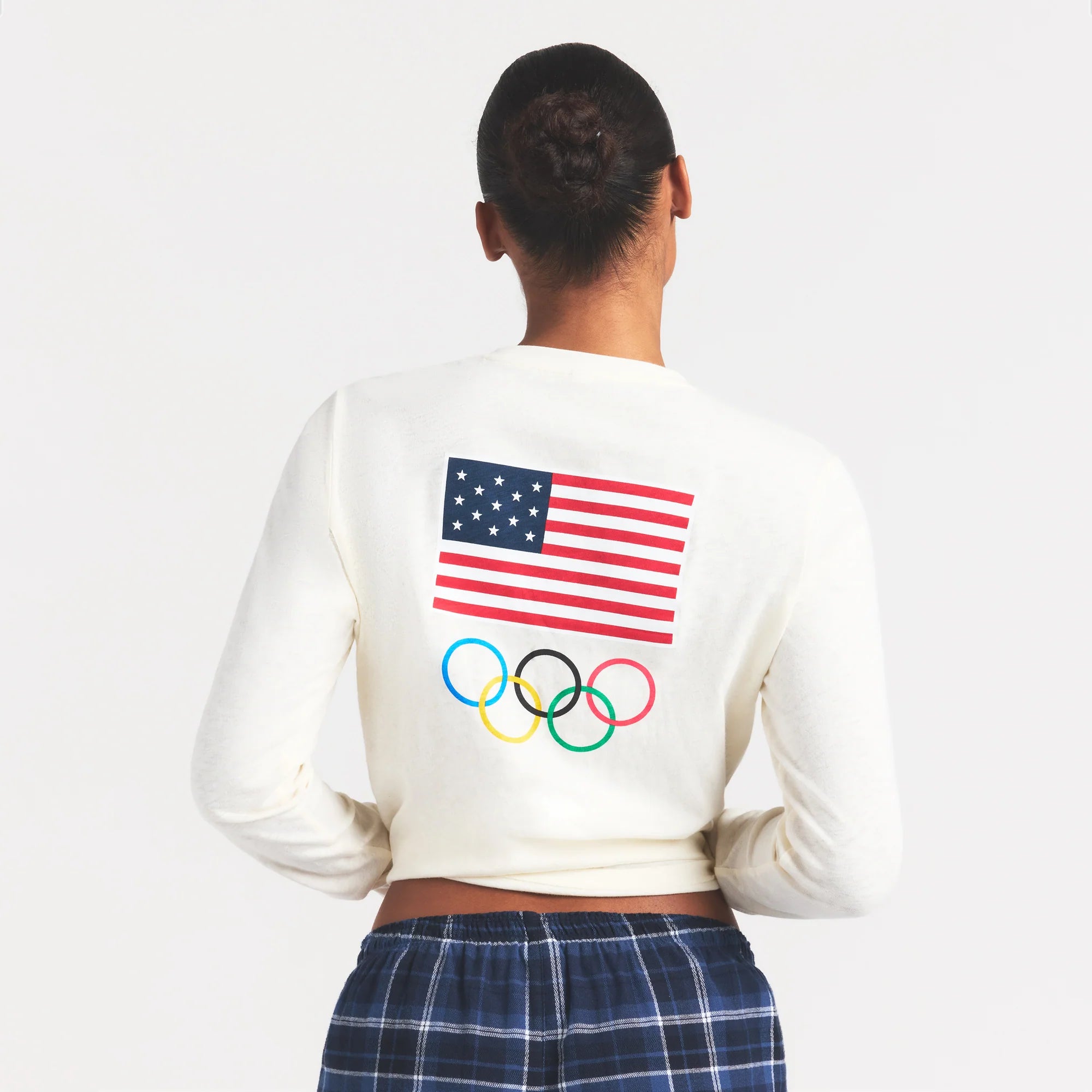 SKIMS FOR TEAM USA WORN IN JERSEY OLYMPIC LONG SLEEVE T-SHIRT | ECRU ON A MODEL SIDE VIEW @ | FOCUS: 0.0, 1.0, 0.9