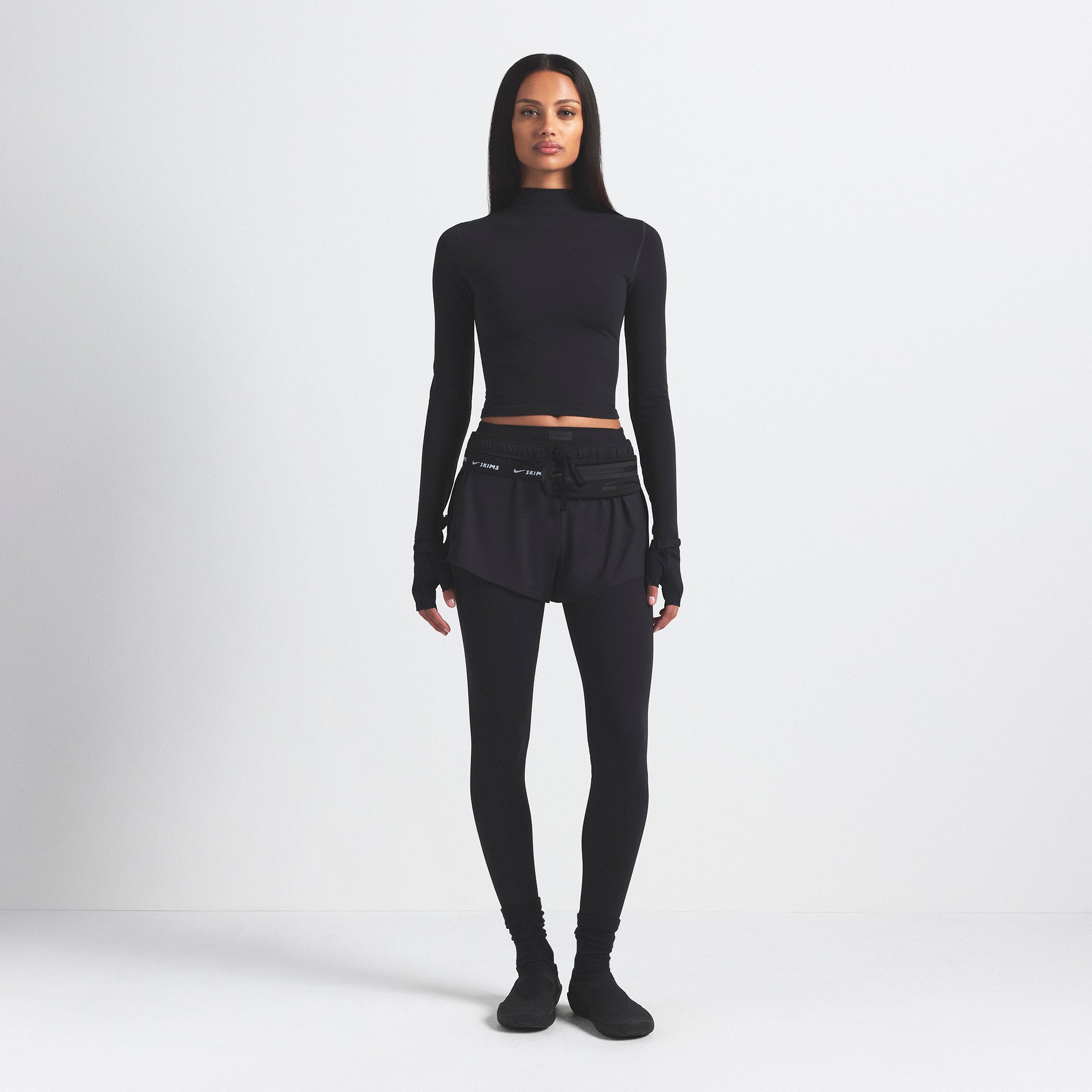 NikeSKIMS VINTAGE SEAMLESS MOCK NECK CROP TOP | OBSIDIAN ON A MODEL FRONT VIEW @ | FOCUS: 0.9, 0.1, 0.7