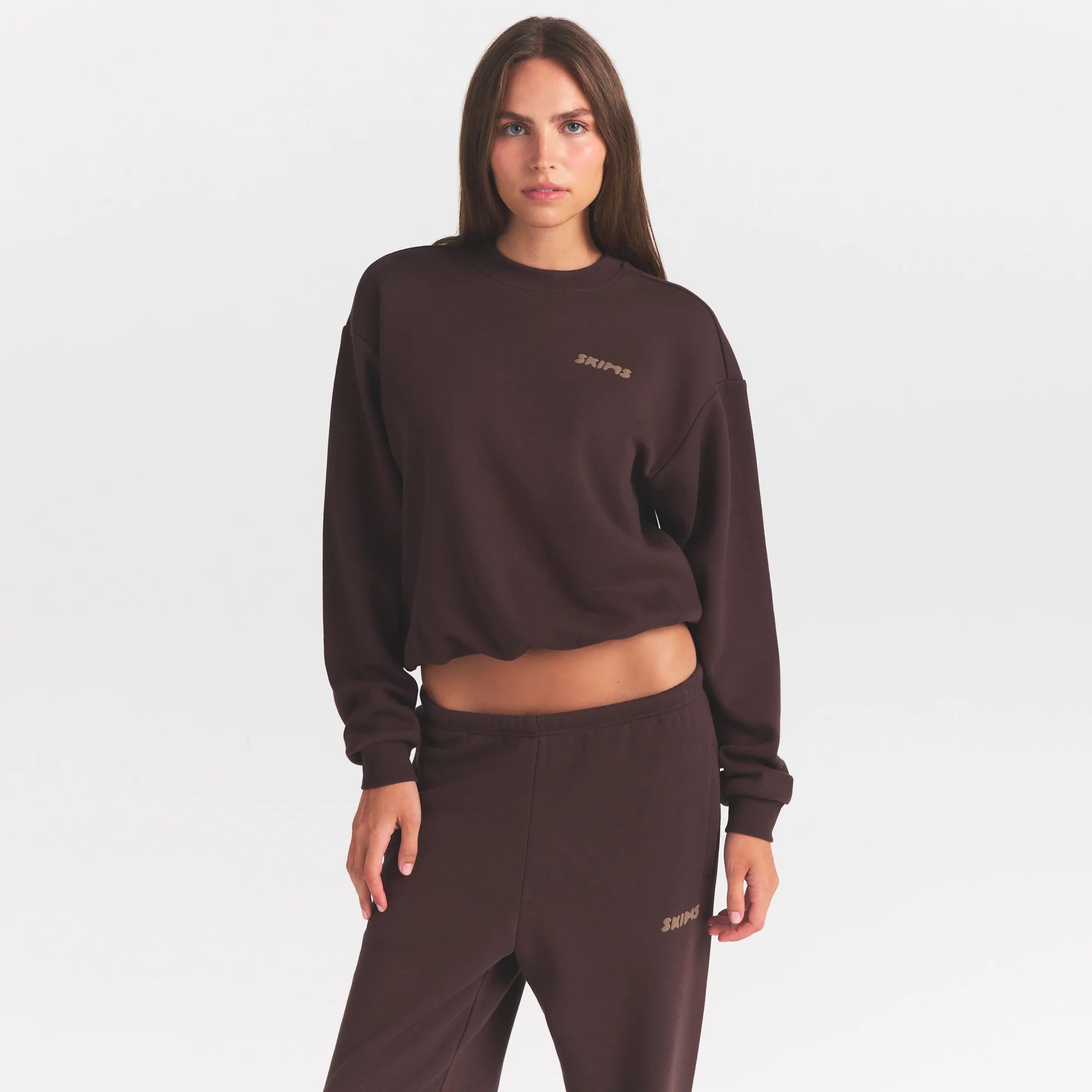 COTTON FLEECE CREWNECK WITH EMBOSSED LOGO | ESPRESSO & LAYS FLAT ON A WHITE BACKGROUND | FLT @ | FOCUS: 0.0, 1.0, 0.9