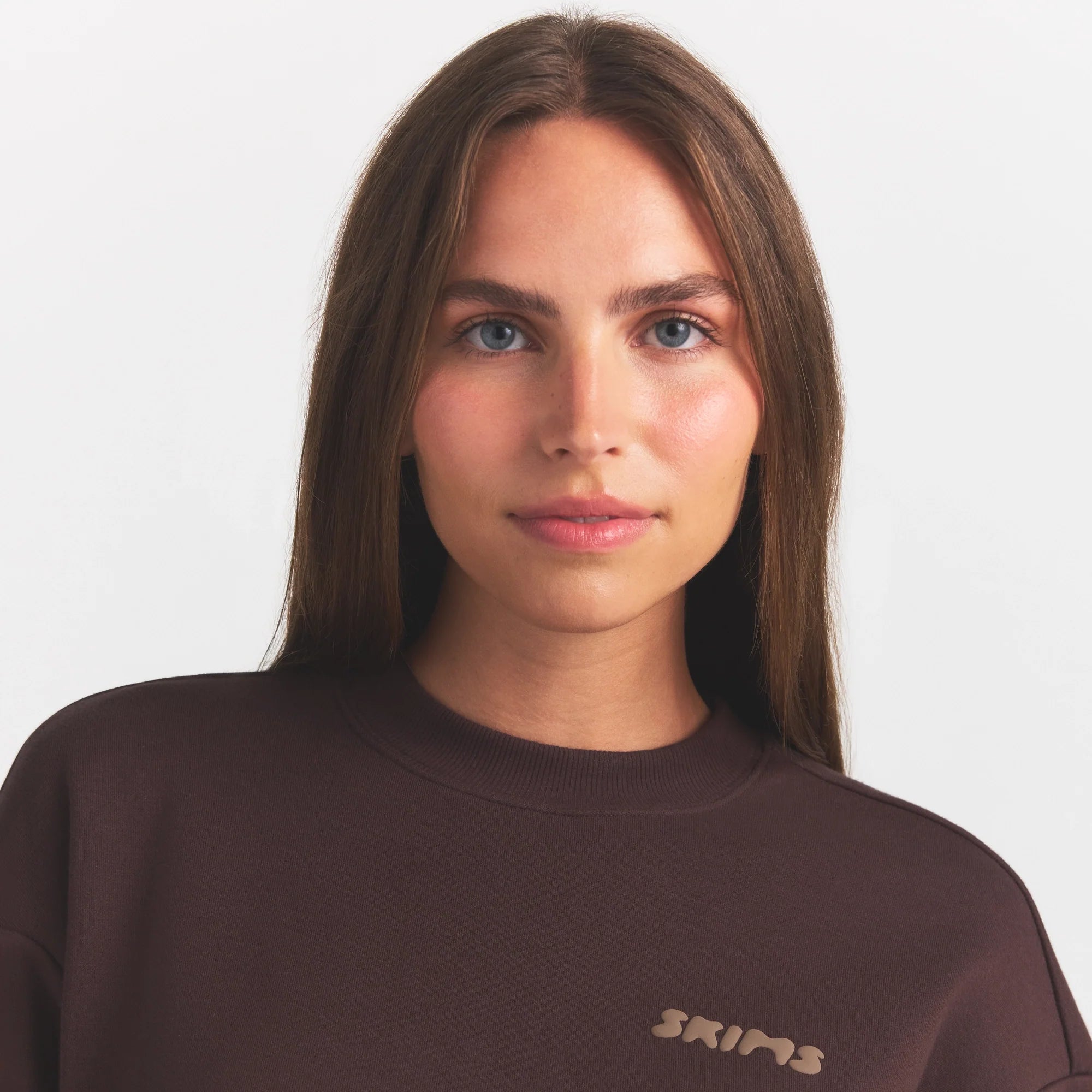 COTTON FLEECE CREWNECK WITH EMBOSSED LOGO | ESPRESSO & LAYS FLAT ON A WHITE BACKGROUND | FLT @ | FOCUS: 0.0, 1.0, 0.9