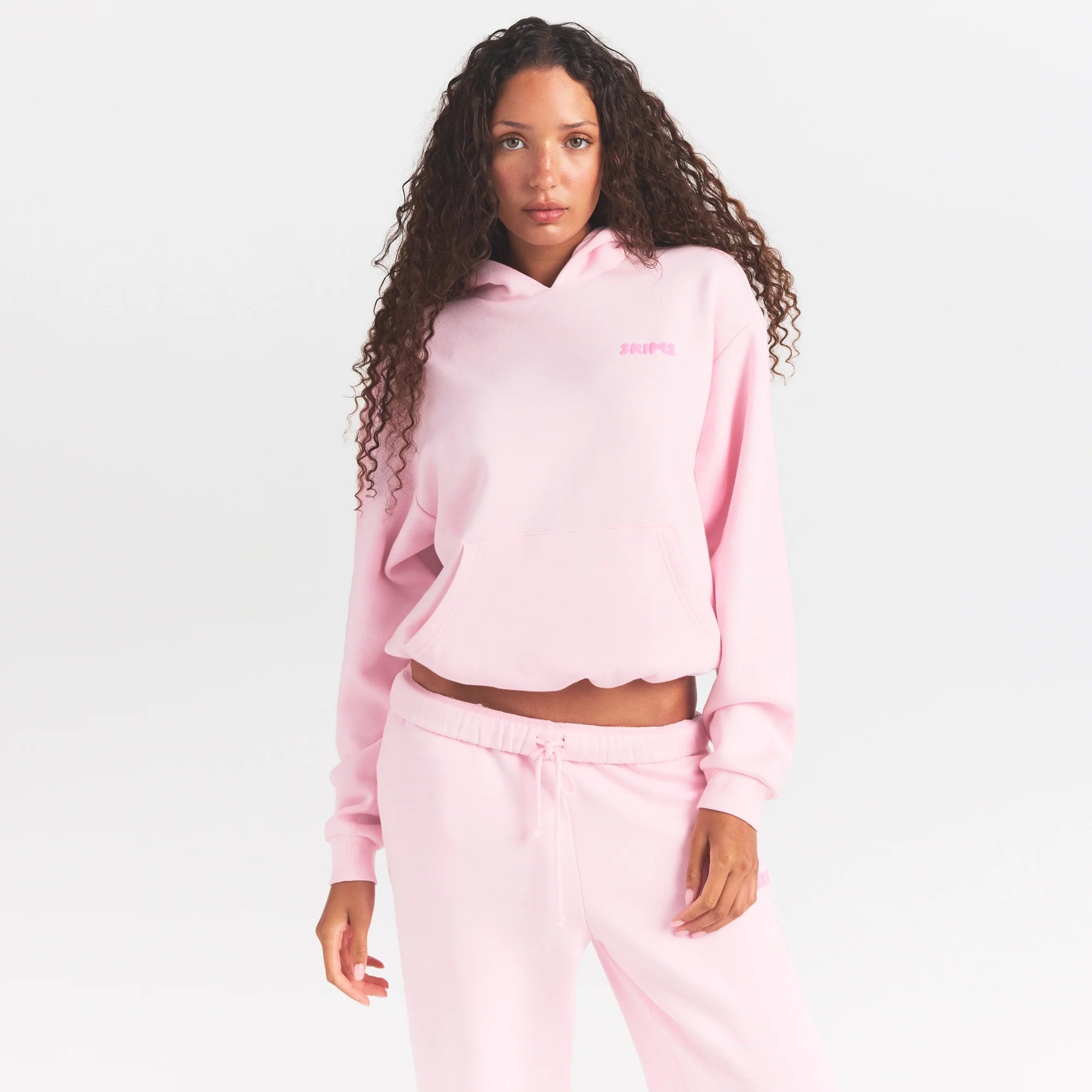 COTTON FLEECE HOODIE WITH EMBOSSED LOGO | CHERRY BLOSSOM ON A MODEL SIDE VIEW @ | FOCUS: 0.0, 1.0, 0.9
