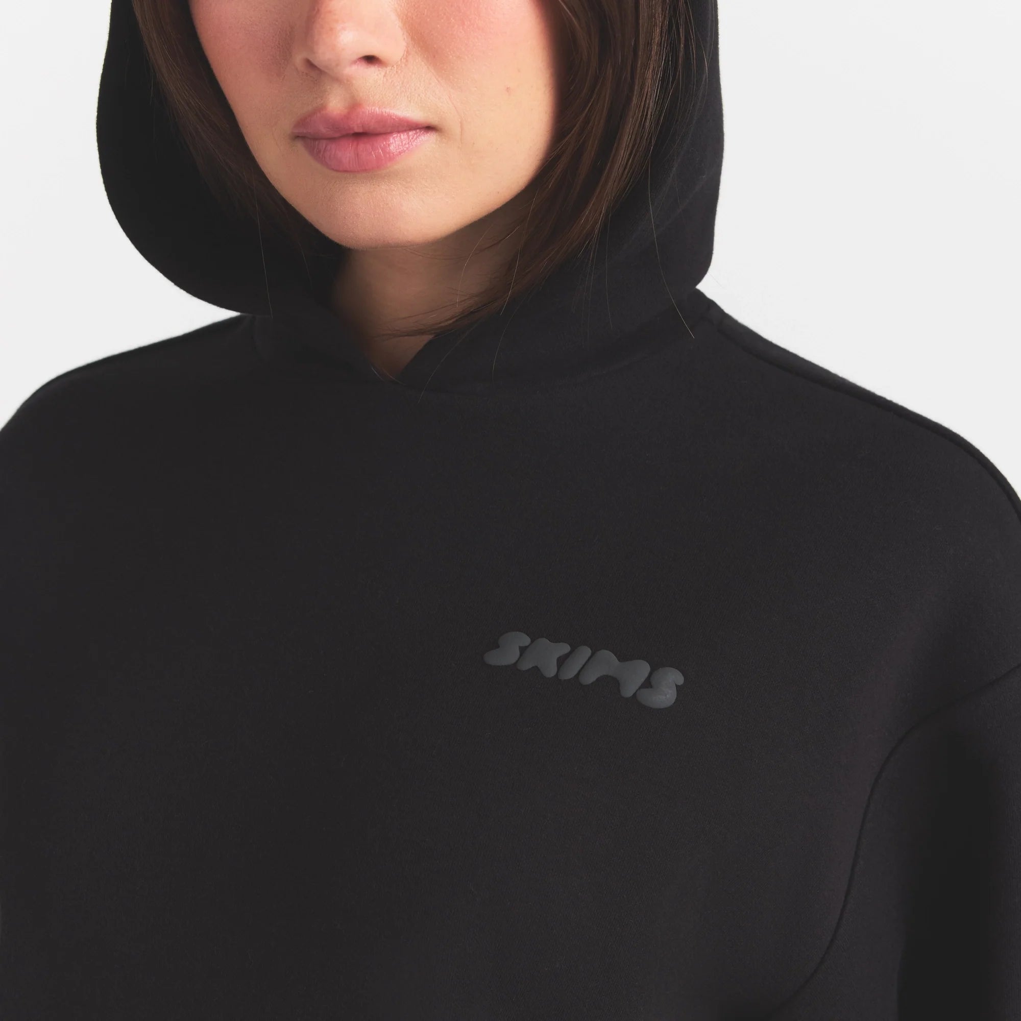 COTTON FLEECE HOODIE WITH EMBOSSED LOGO | ONYX ON A MODEL SIDE VIEW @ | FOCUS: 0.0, 1.0, 0.9