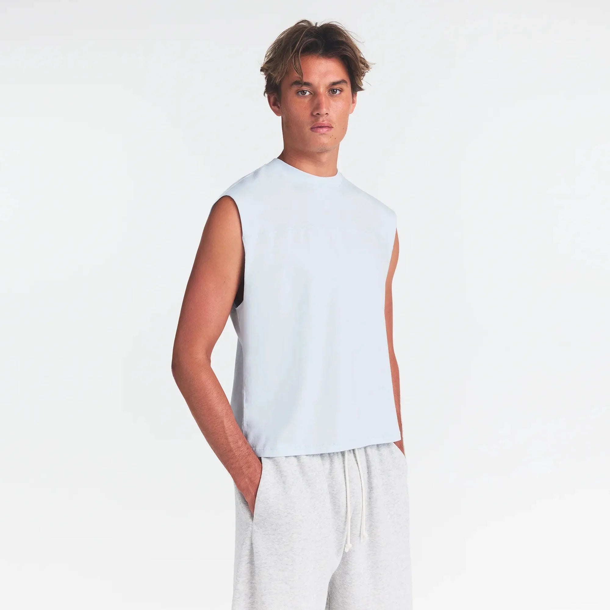 HEAVYWEIGHT COTTON MENS CROPPED TANK | ATMOSPHERE ON A MODEL SIDE VIEW @ | FOCUS: 0.0, 1.0, 0.9