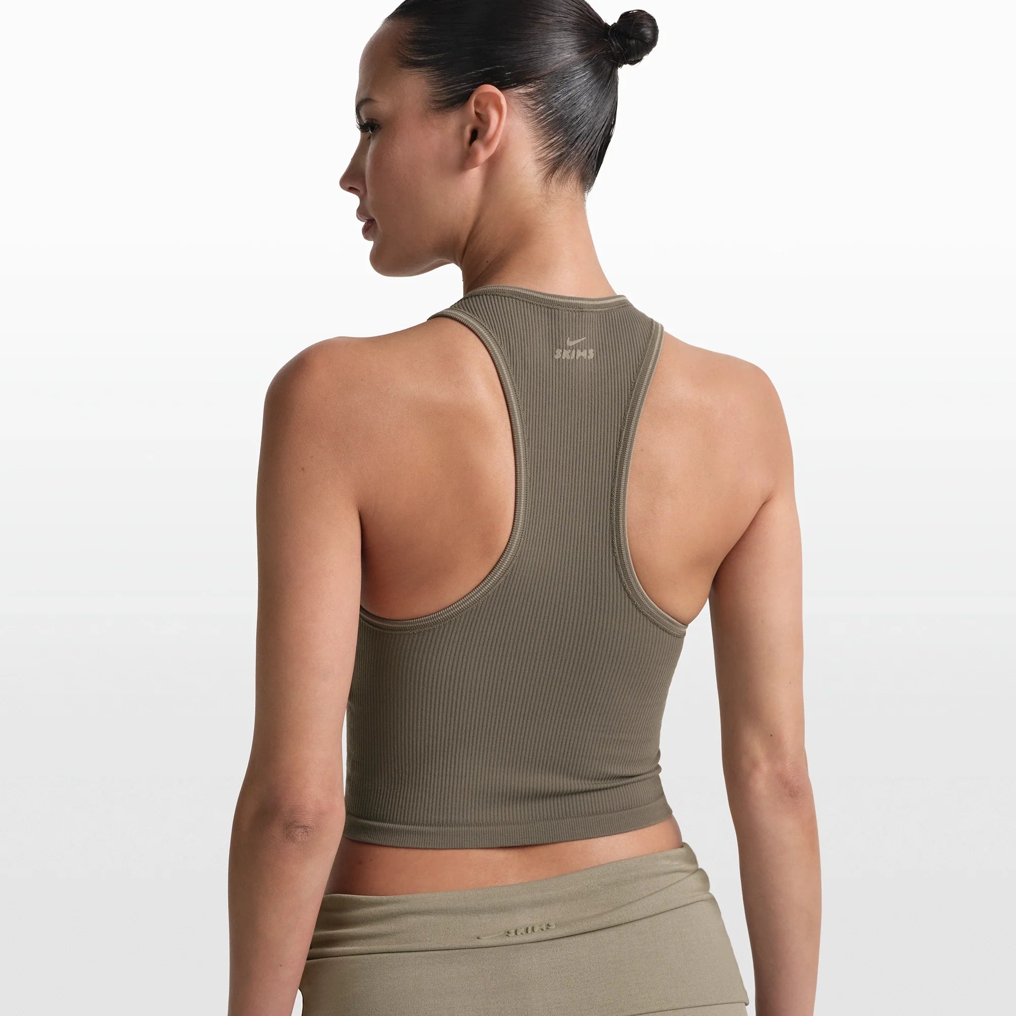 NikeSKIMS RIBBED SEAMLESS RACER FRONT TANK | DUSTY OAKMOSS/DUNE ON A MODEL FRONT VIEW @ | FOCUS: 0.0, 1.0, 0.9
