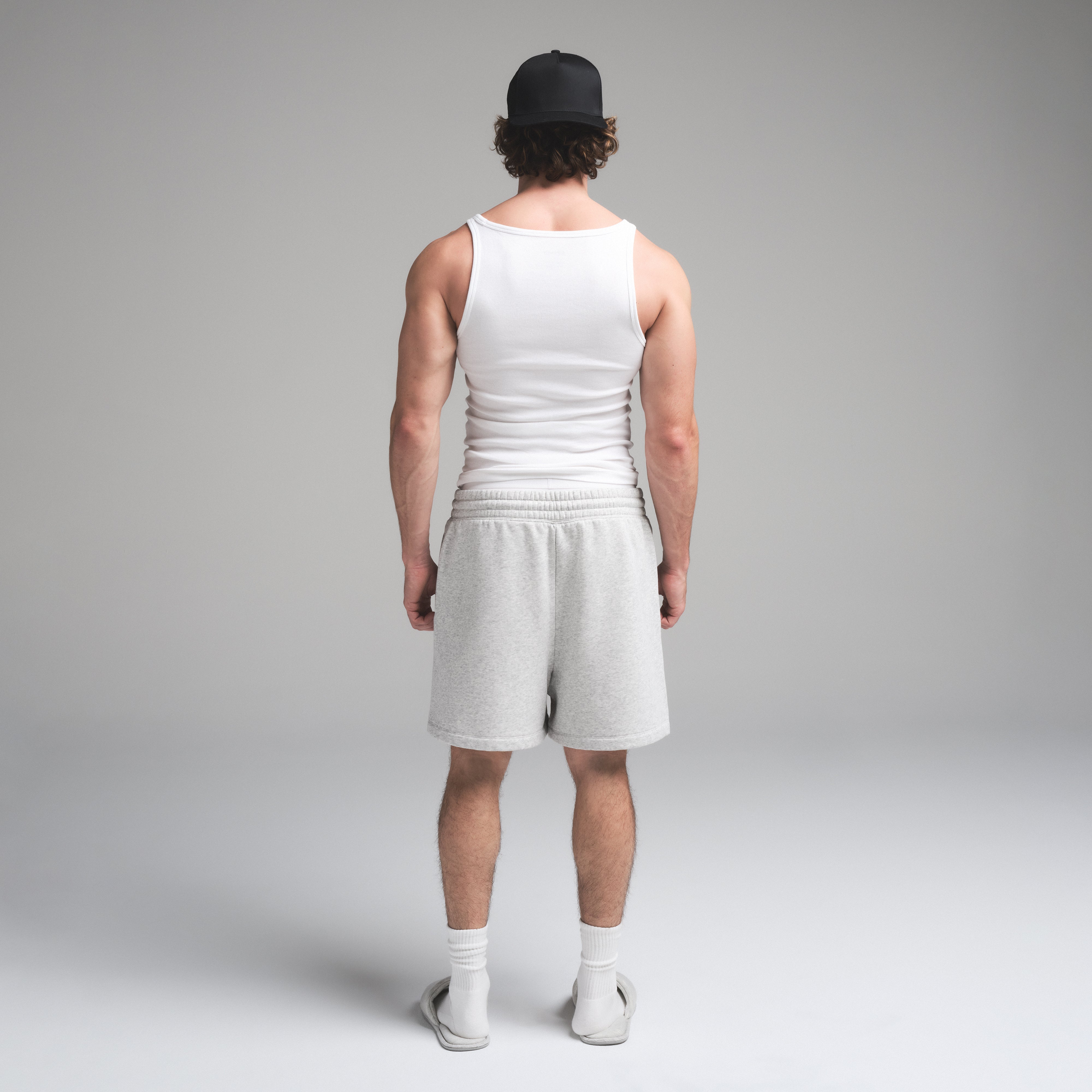 SKIMS COTTON MENS RIB TANK 3-PACK | CHALK ON A MODEL SIDE VIEW | FOCUS: 0.0, 1.0, 0.9