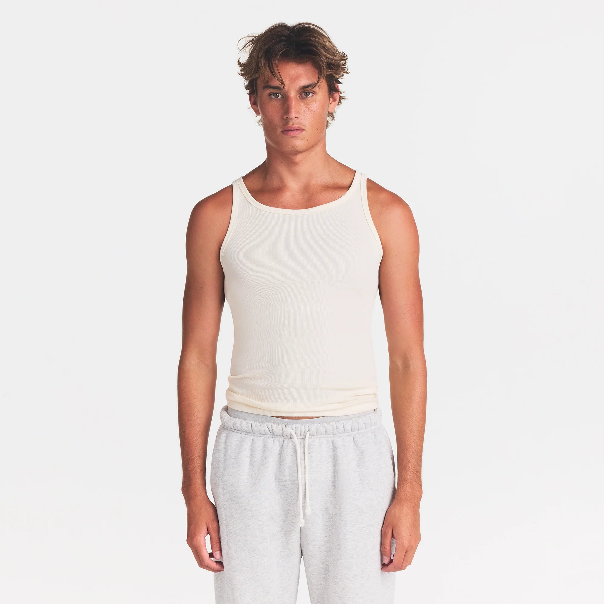 SKIMS COTTON MENS RIB TANK 3-PACK | ECRU MULTI ON A MODEL FRONT VIEW