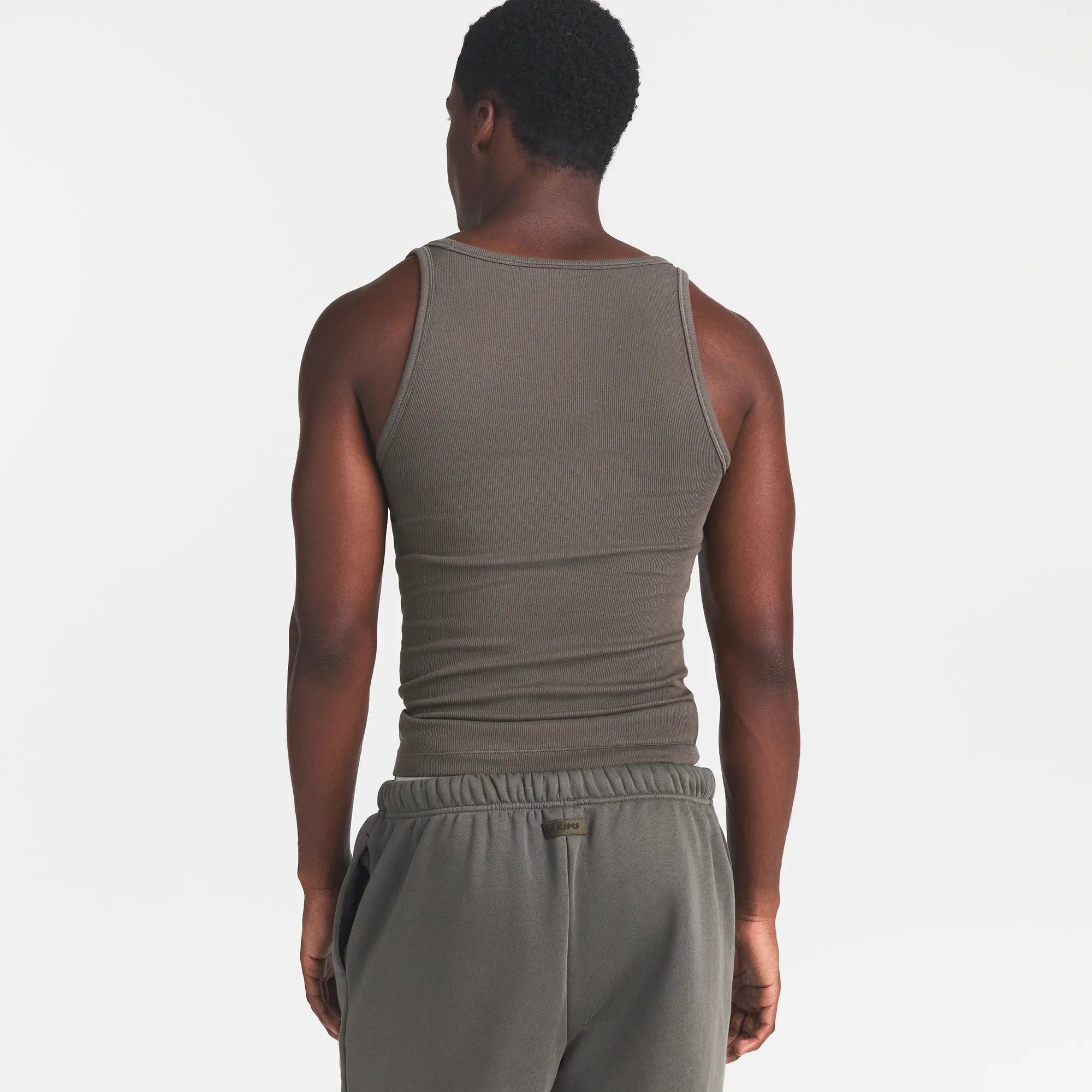 SKIMS COTTON MENS RIB TANK 3-PACK | JUNGLE MULTI ON A MODEL BACK VIEW @ | FOCUS: 0.0, 1.0, 0.9