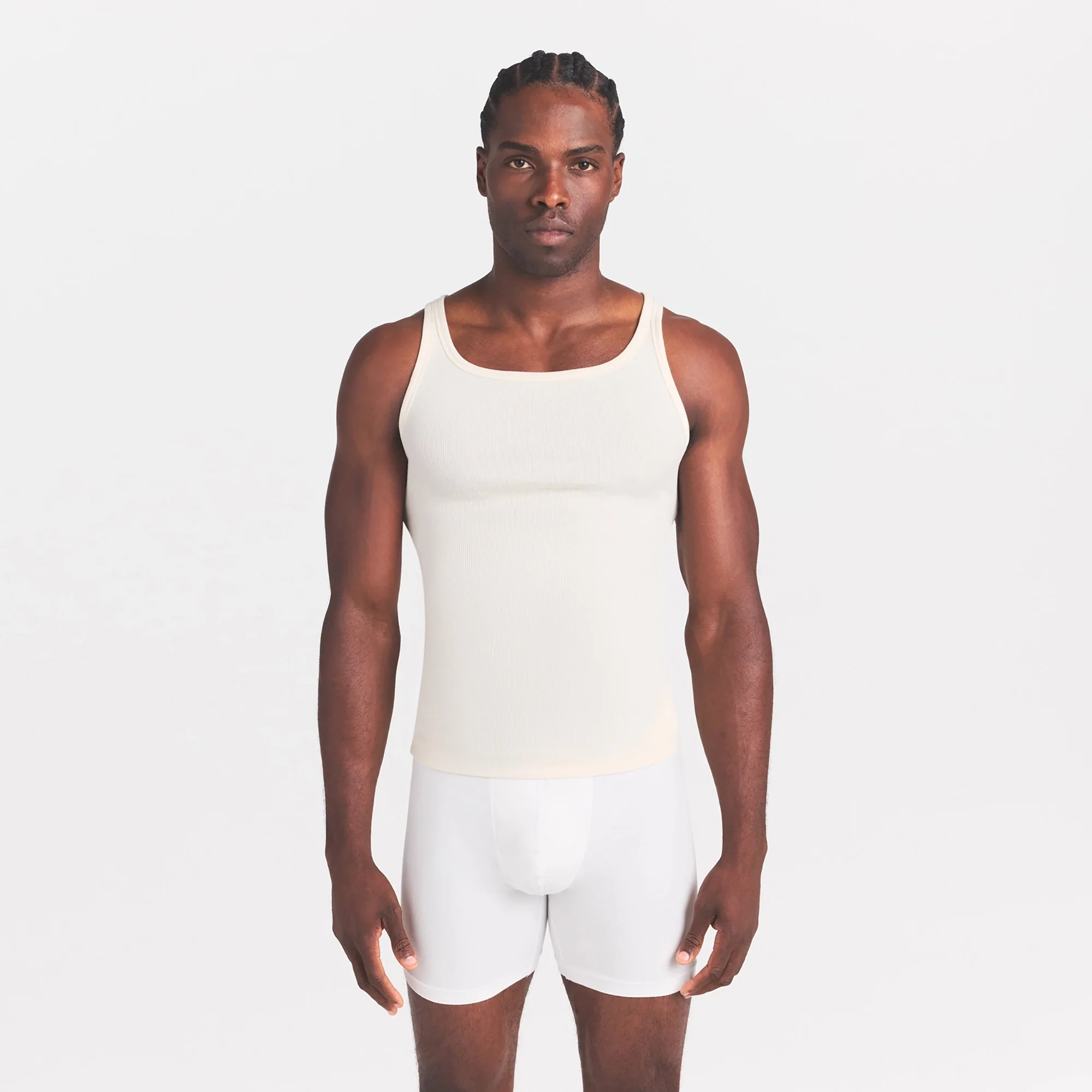 SKIMS COTTON RIB MENS TANK 3-PACK | LINEN ECRU MULTI ON A MODEL SIDE VIEW @ | FOCUS: 0.0, 1.0, 0.9