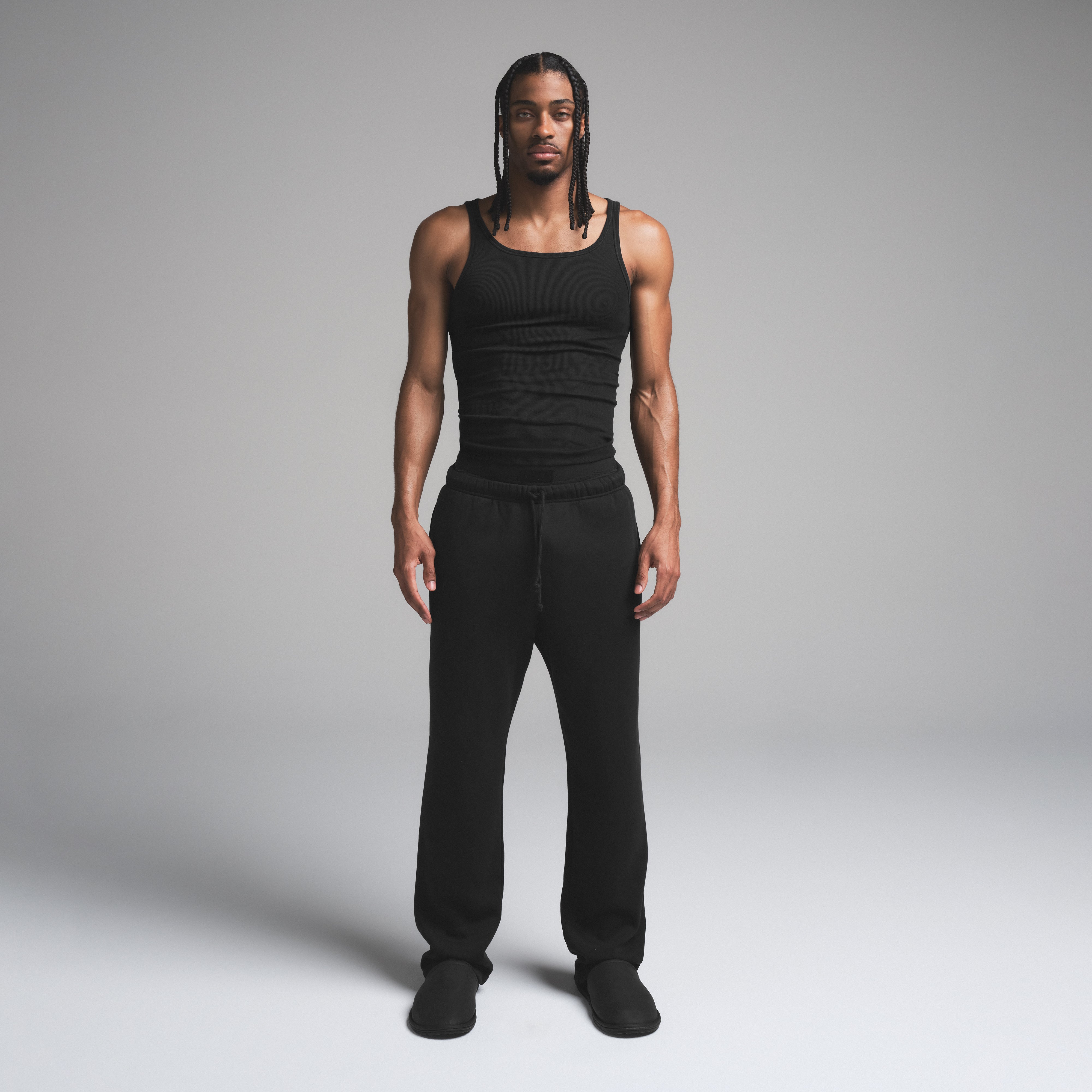 SKIMS COTTON MENS RIB TANK 3-PACK | ONYX ON A MODEL FRONT VIEW | FOCUS: 0.0, 1.0, 0.9