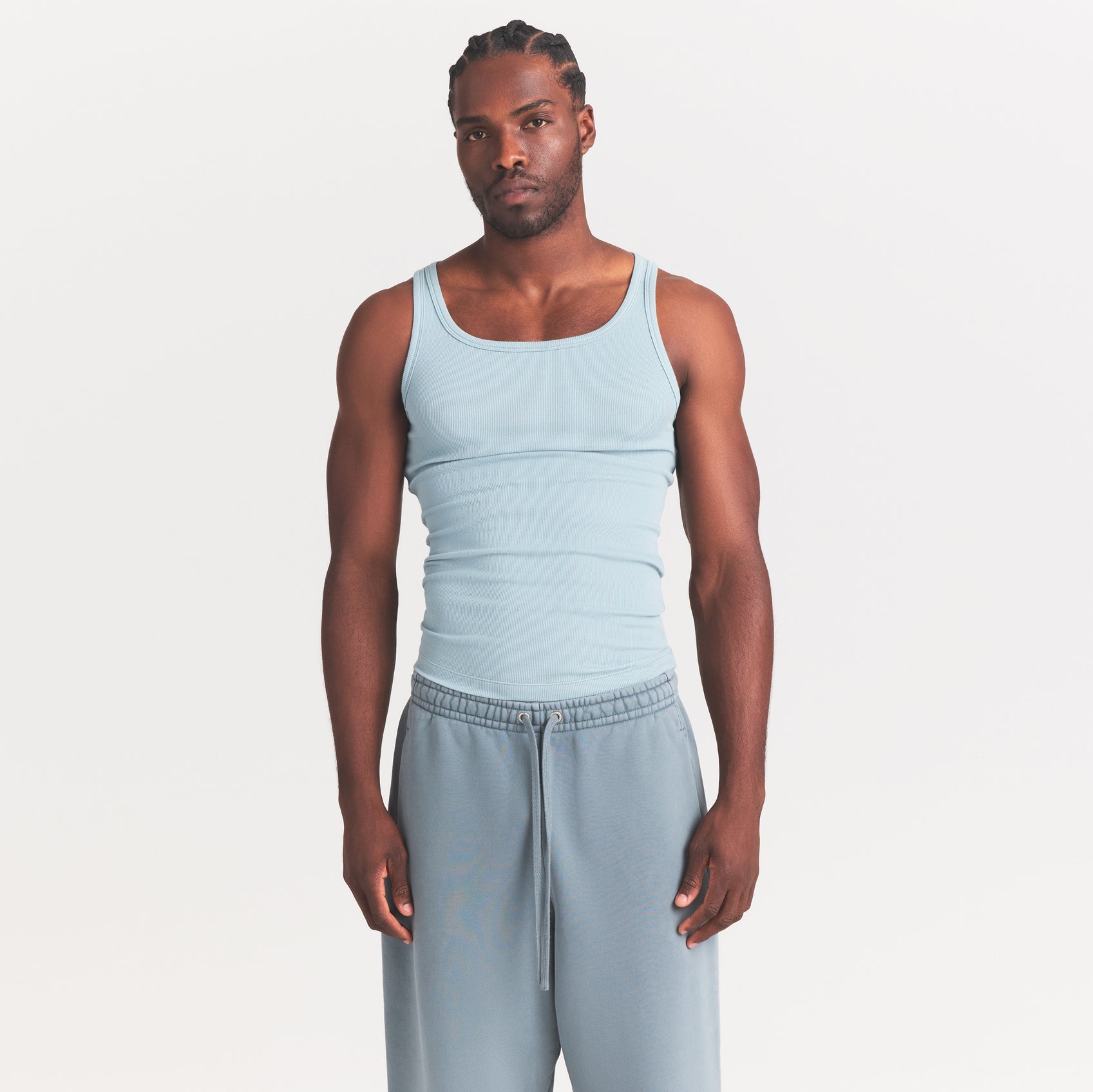 SKIMS COTTON MENS RIB TANK 3-PACK | VERDANT DARK SEPIA MULTI ON A MODEL SIDE VIEW @ | FOCUS: 0.0, 1.0, 0.9