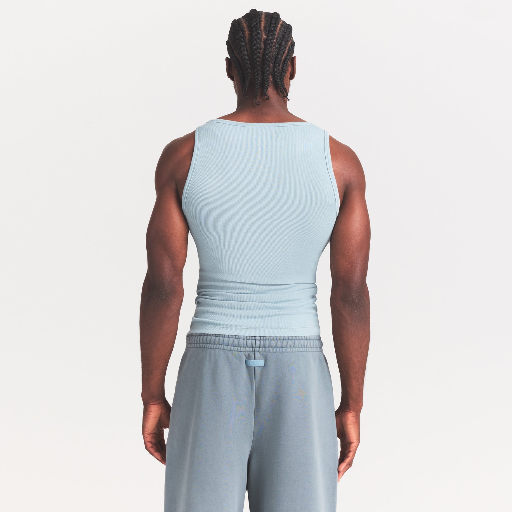 SKIMS COTTON MENS RIB TANK 3-PACK | VERDANT DARK SEPIA MULTI ON A MODEL SIDE VIEW @ | FOCUS: 0.0, 1.0, 0.9