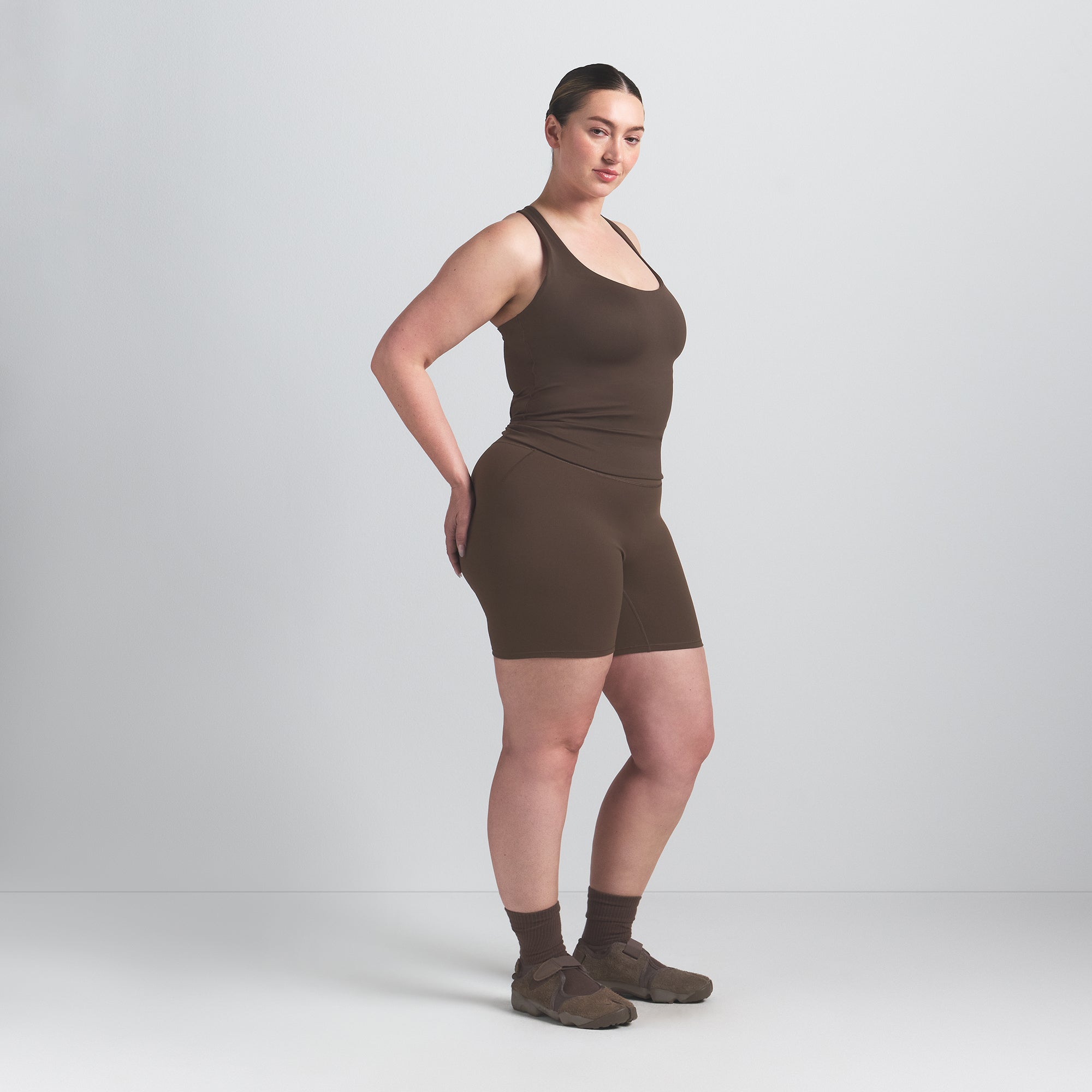 NikeSKIMS MATTE RACER BACK TANK | DARK SEPIA ON A MODEL SIDE VIEW