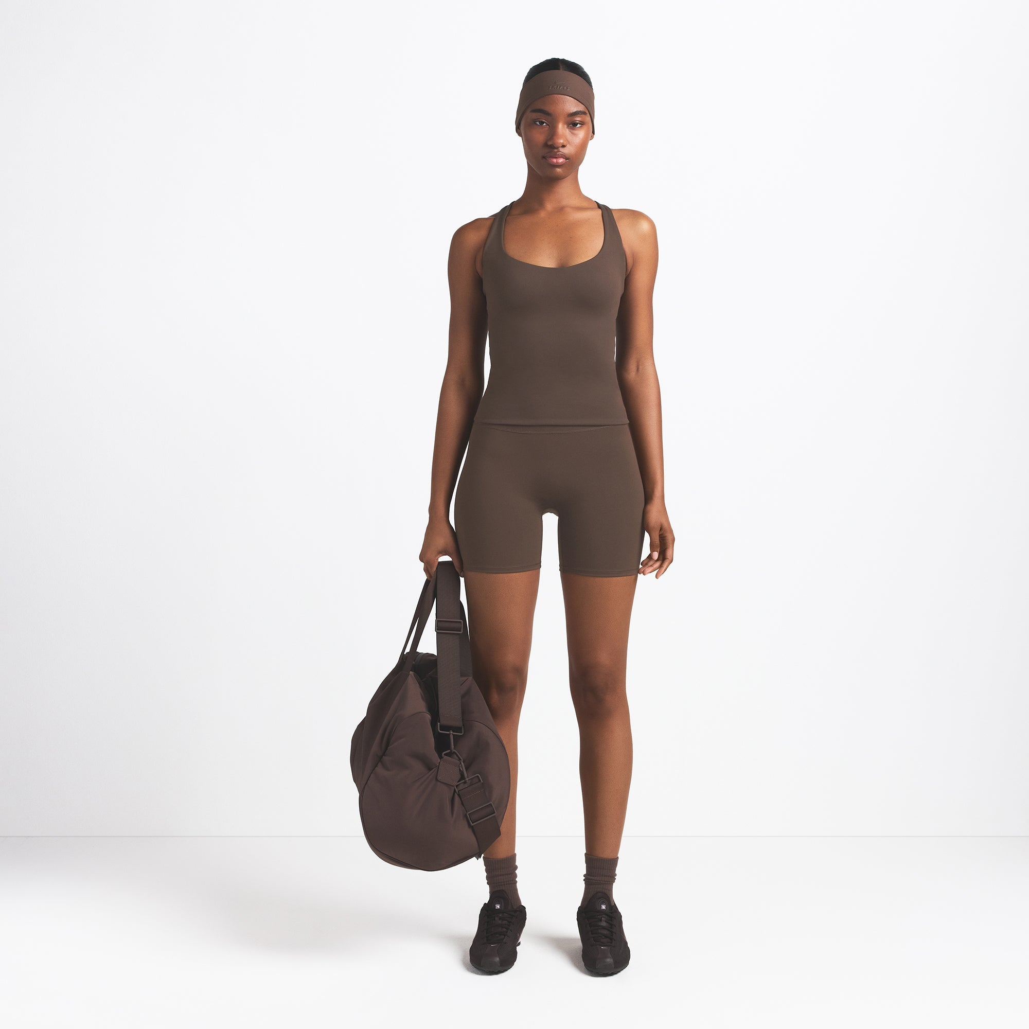 NikeSKIMS MATTE RACER BACK TANK | DARK SEPIA ON A MODEL FRONT VIEW @ | FOCUS: 0.9, 0.1, 0.7