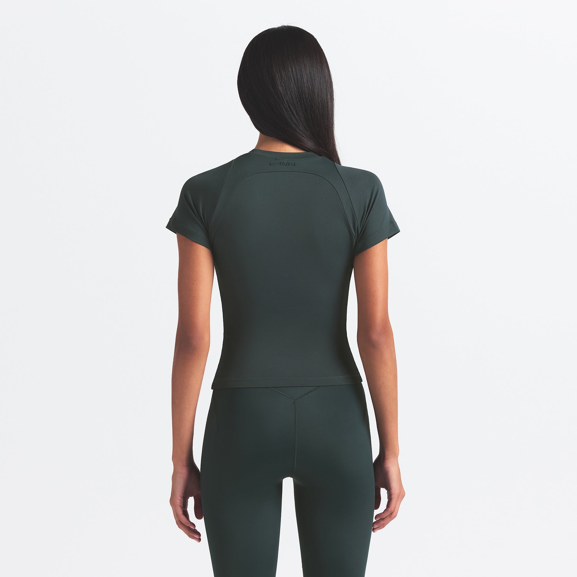 NikeSKIMS AIRY BABY TEE | DARK TEAL ON A MODEL SIDE VIEW @ | FOCUS: 0.0, 1.0, 0.9