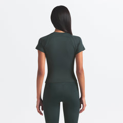 NikeSKIMS AIRY BABY TEE | DARK TEAL ON A MODEL SIDE VIEW @ | FOCUS: 0.0, 1.0, 0.9