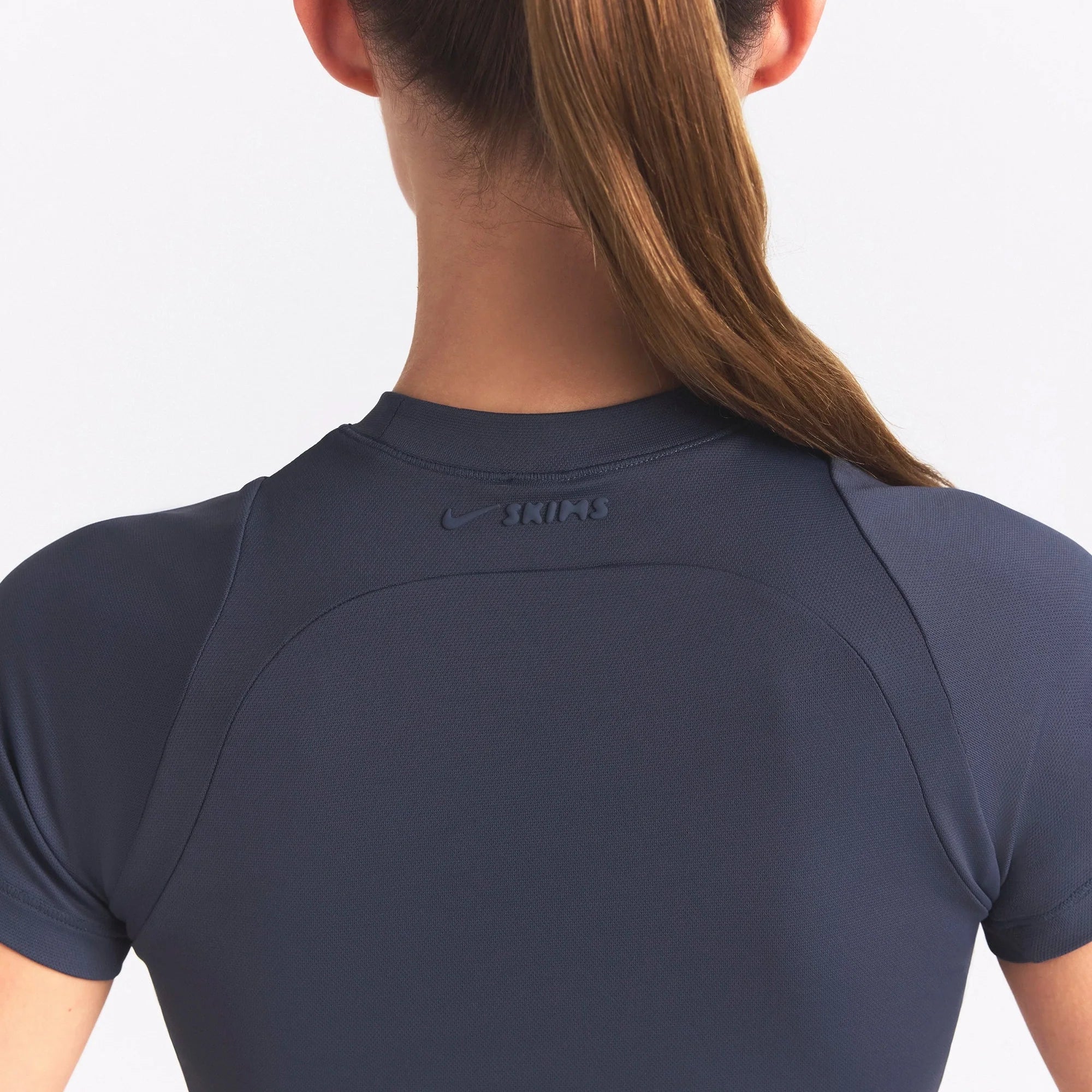 NikeSKIMS AIRY BABY TEE | DEEP ROYAL ON A MODEL SIDE VIEW @ | FOCUS: 0.0, 1.0, 0.9