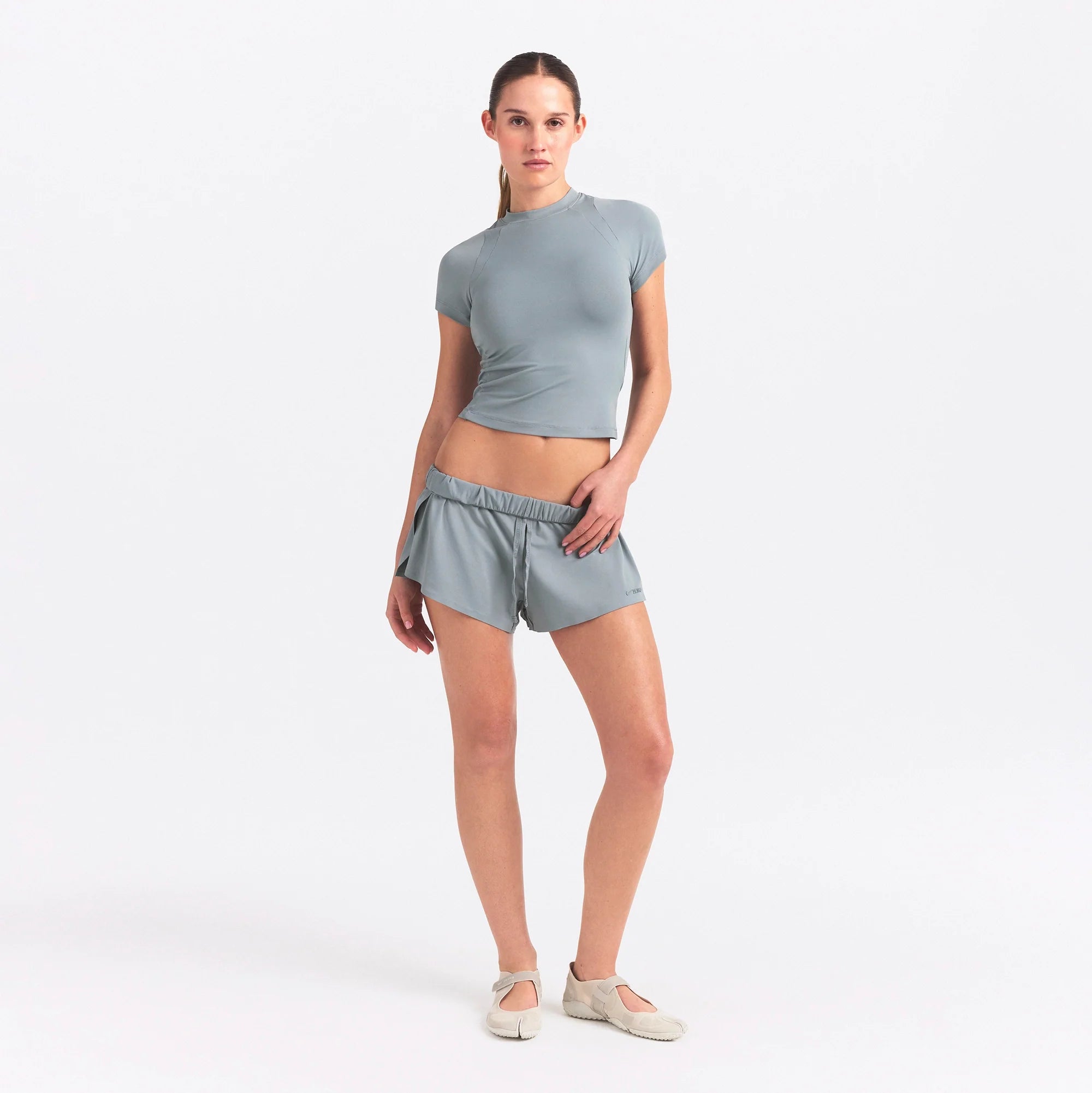 NikeSKIMS AIRY BABY TEE | WASHED PACIFIC ON A MODEL FRONT VIEW @ | FOCUS: 0.0, 1.0, 0.9