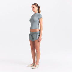 NikeSKIMS AIRY BABY TEE | WASHED PACIFIC ON A MODEL SIDE VIEW @ | FOCUS: 0.0, 1.0, 0.9