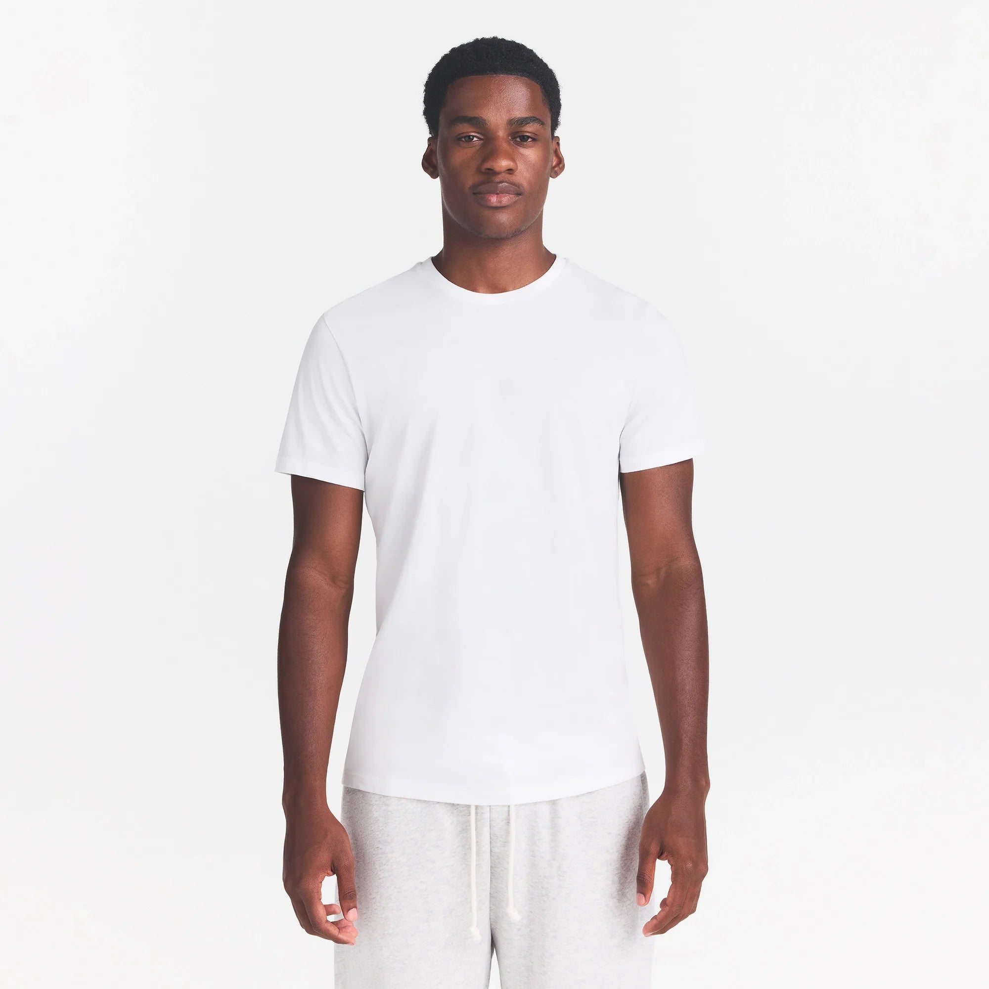 SKIMS COTTON MENS CLASSIC T-SHIRT | CHALK ON A MODEL FRONT VIEW  @ | FOCUS: 0.0, 1.0, 0.9