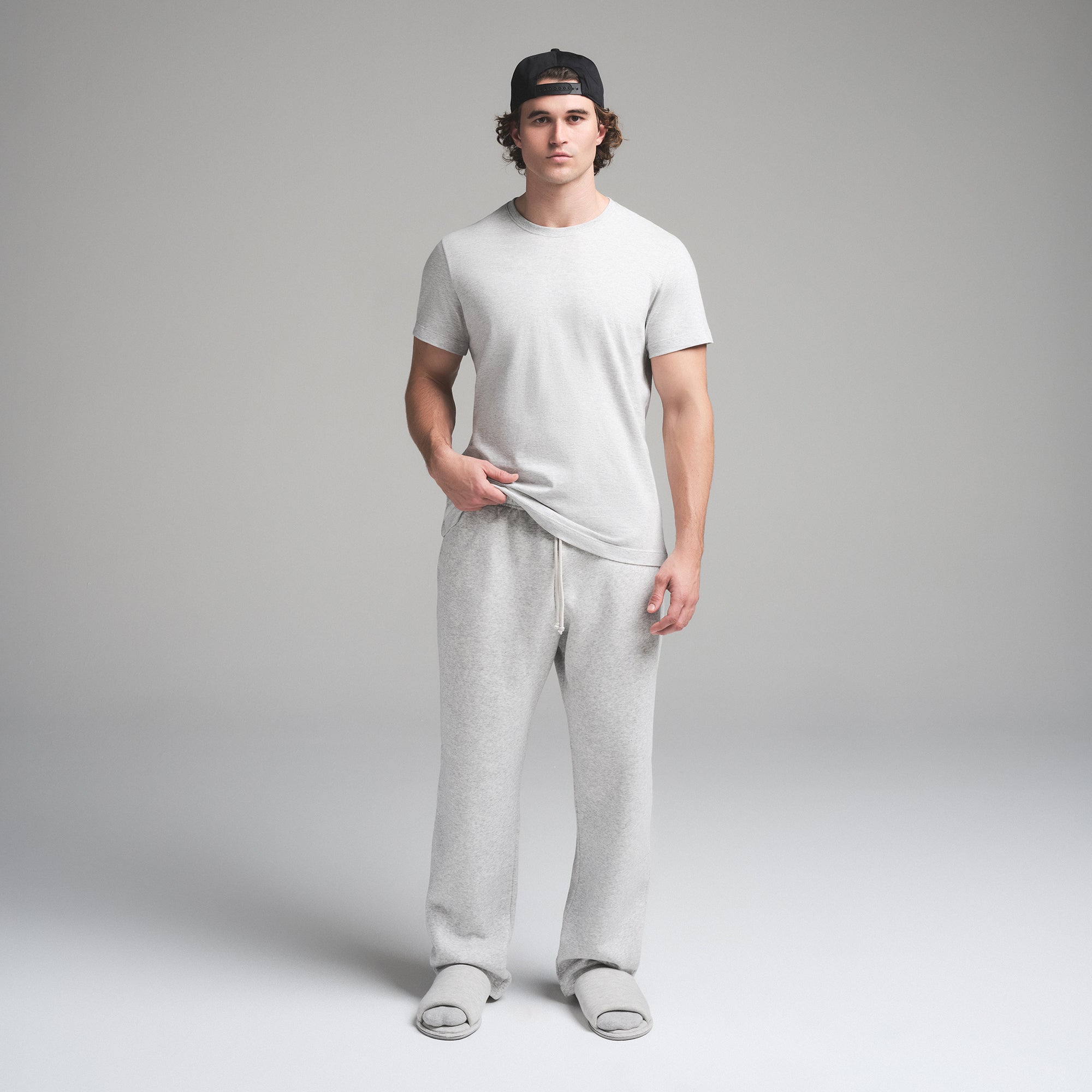 SKIMS COTTON MENS CLASSIC T-SHIRT | LIGHT HEATHER GREY ON A MODEL FRONT VIEW | FOCUS: 0.0, 1.0, 0.9