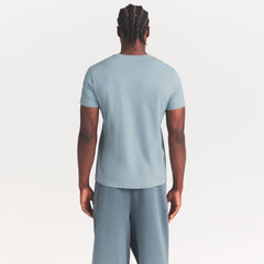 SKIMS COTTON MENS CLASSIC T-SHIRT | SKY ON A MODEL SIDE VIEW @ | FOCUS: 0.0, 1.0, 0.9