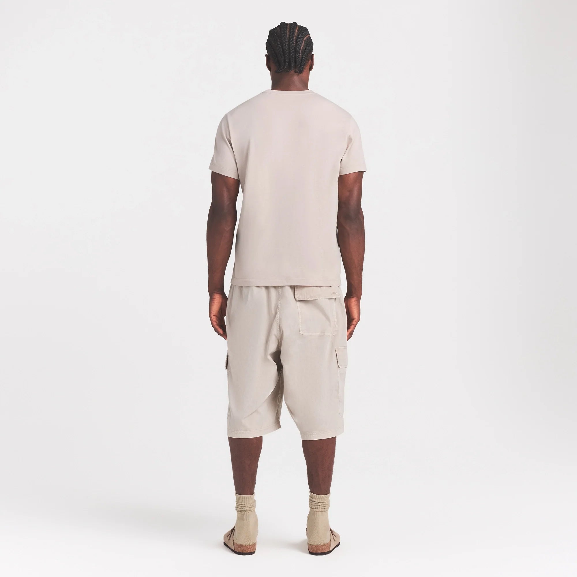 SKIMS COTTON MENS CLASSIC T-SHIRT | STONE ON A MODEL FRONT VIEW @ | FOCUS: 0.0, 1.0, 0.9