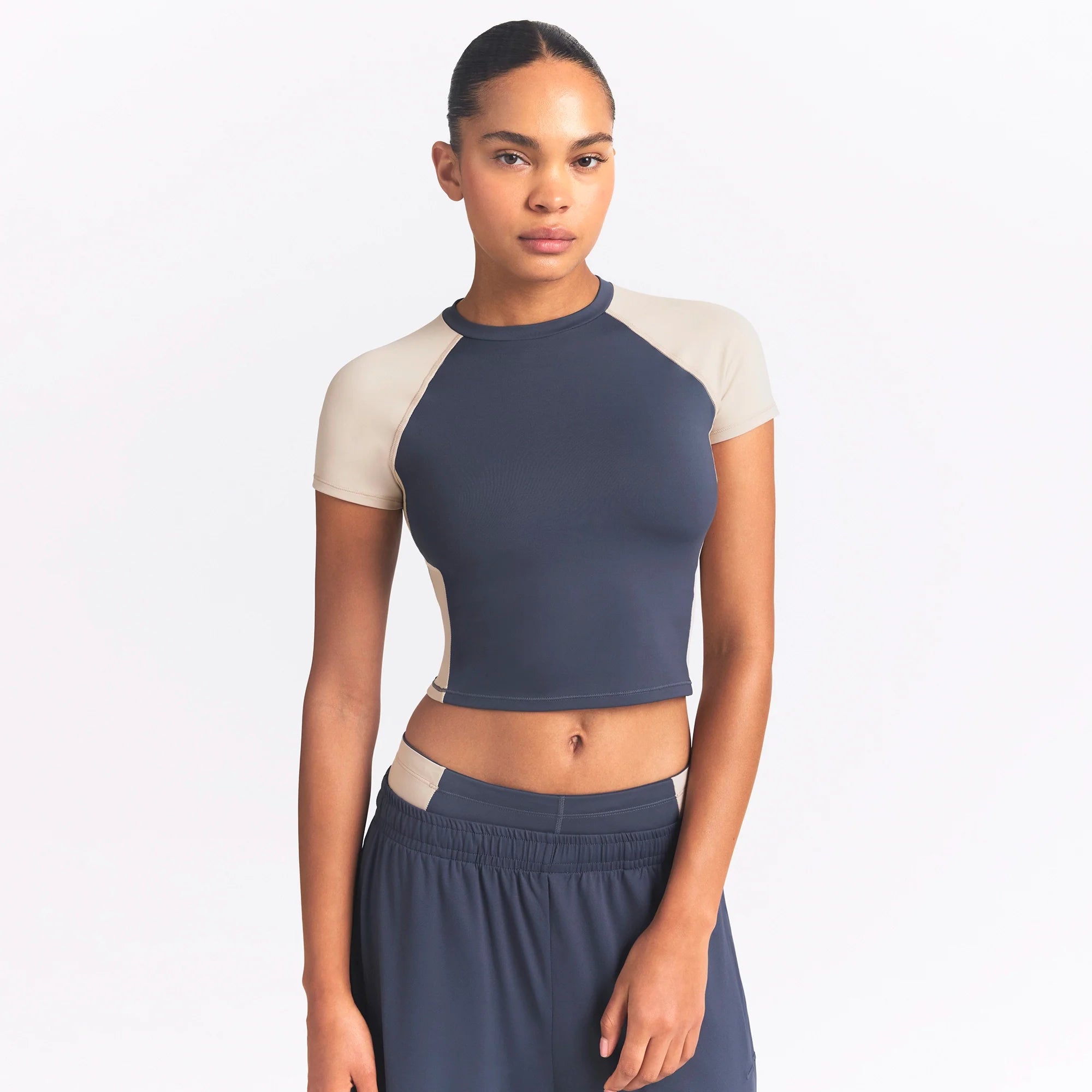 NikeSKIMS MATTE AND SHINE CREWNECK CROP SHORT SLEEVE | DEEP ROYAL/STONE ON A MODEL SIDE VIEW @ | FOCUS: 0.0, 1.0, 0.9