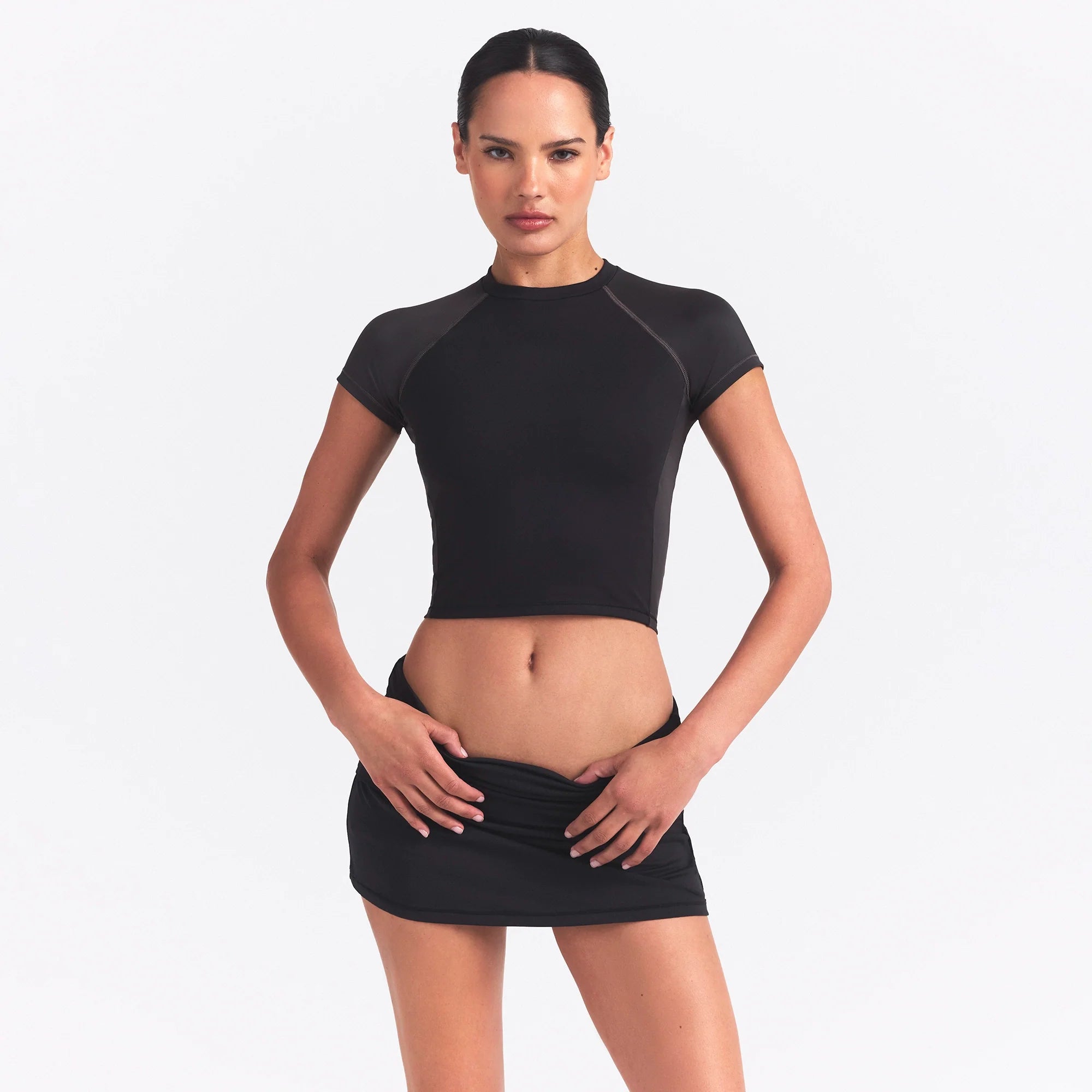 NikeSKIMS MATTE AND SHINE CREWNECK CROP SHORT SLEEVE | OBSIDIAN/IGNEOUS ON A MODEL SIDE VIEW @ | FOCUS: 0.0, 1.0, 0.9