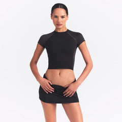 NikeSKIMS MATTE AND SHINE CREWNECK CROP SHORT SLEEVE | OBSIDIAN/IGNEOUS ON A MODEL SIDE VIEW @ | FOCUS: 0.0, 1.0, 0.9