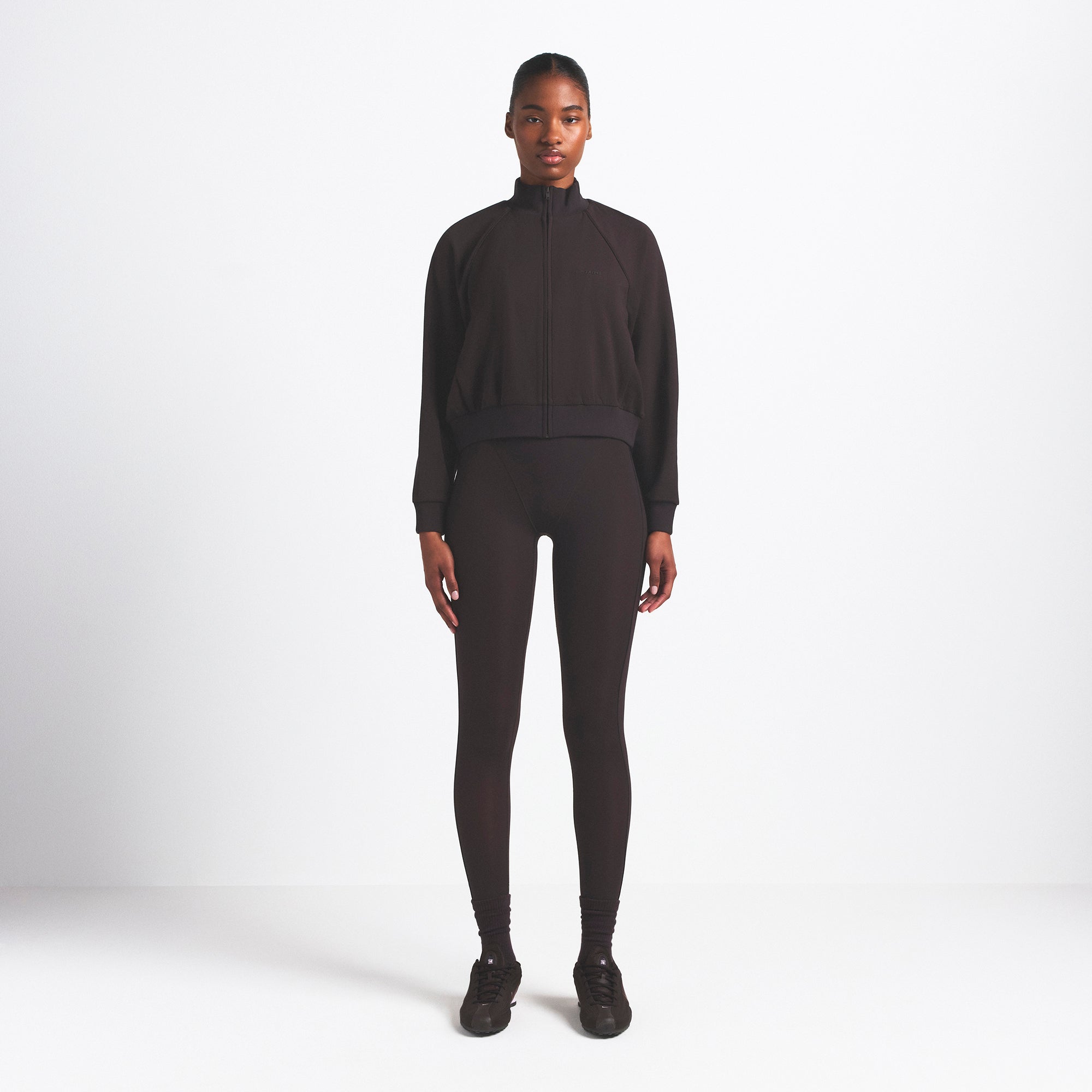 NikeSKIMS MATTE TRICOT TRACK JACKET | DARK ROAST ON A MODEL FRONT VIEW @ | FOCUS: 0.0, 1.0, 0.9