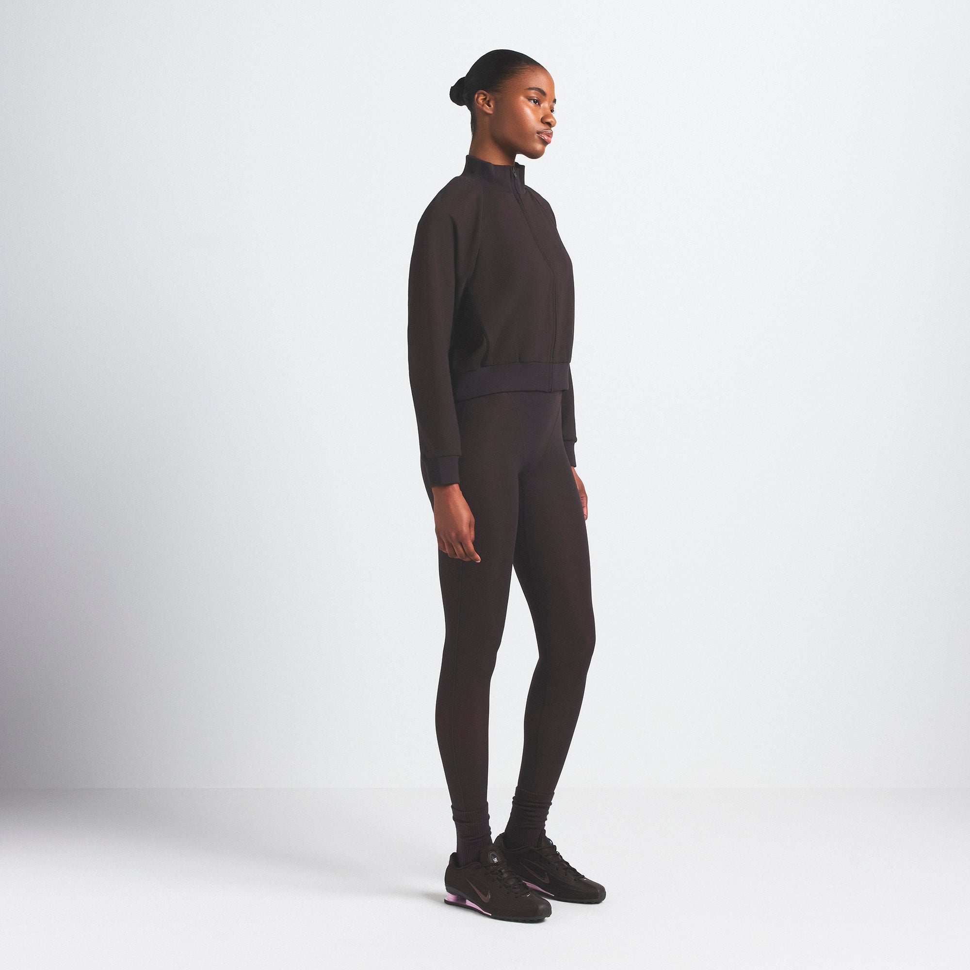 NikeSKIMS MATTE TRICOT TRACK JACKET | DARK ROAST ON A MODEL SIDE VIEW @ | FOCUS: 0.0, 1.0, 0.9