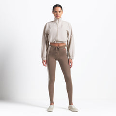 NikeSKIMS WOVEN NYLON CROP JACKET | STONE ON A MODEL FRONT VIEW @ | FOCUS: 0.0, 1.0, 0.9