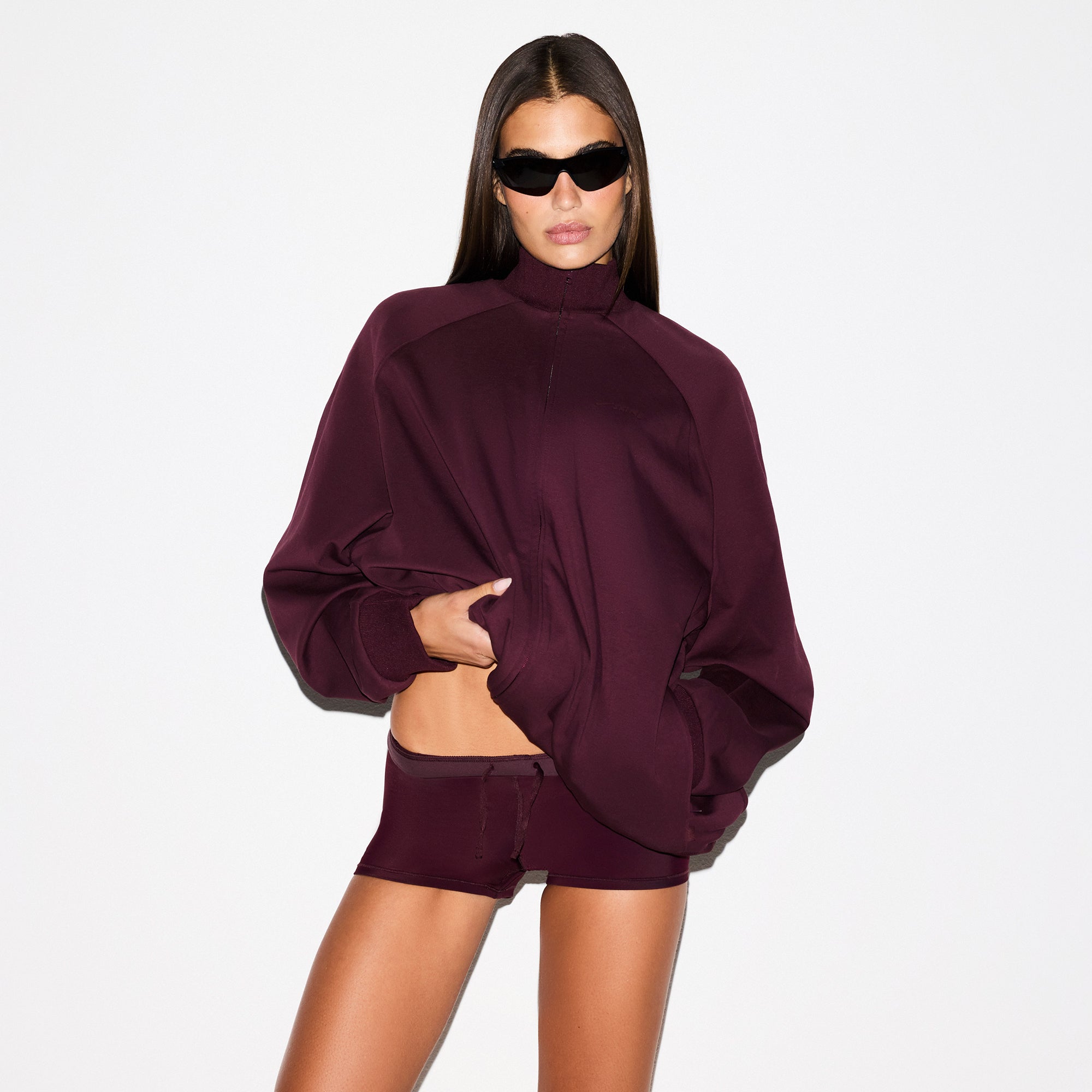 NikeSKIMS MATTE TRICOT OVERSIZED TRACK JACKET | CURRANT ON A MODEL SIDE VIEW @ | FOCUS: 0.0, 1.0, 0.9