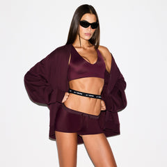 NikeSKIMS MATTE TRICOT OVERSIZED TRACK JACKET | CURRANT ON A MODEL SIDE VIEW @ | FOCUS: 0.0, 1.0, 0.9