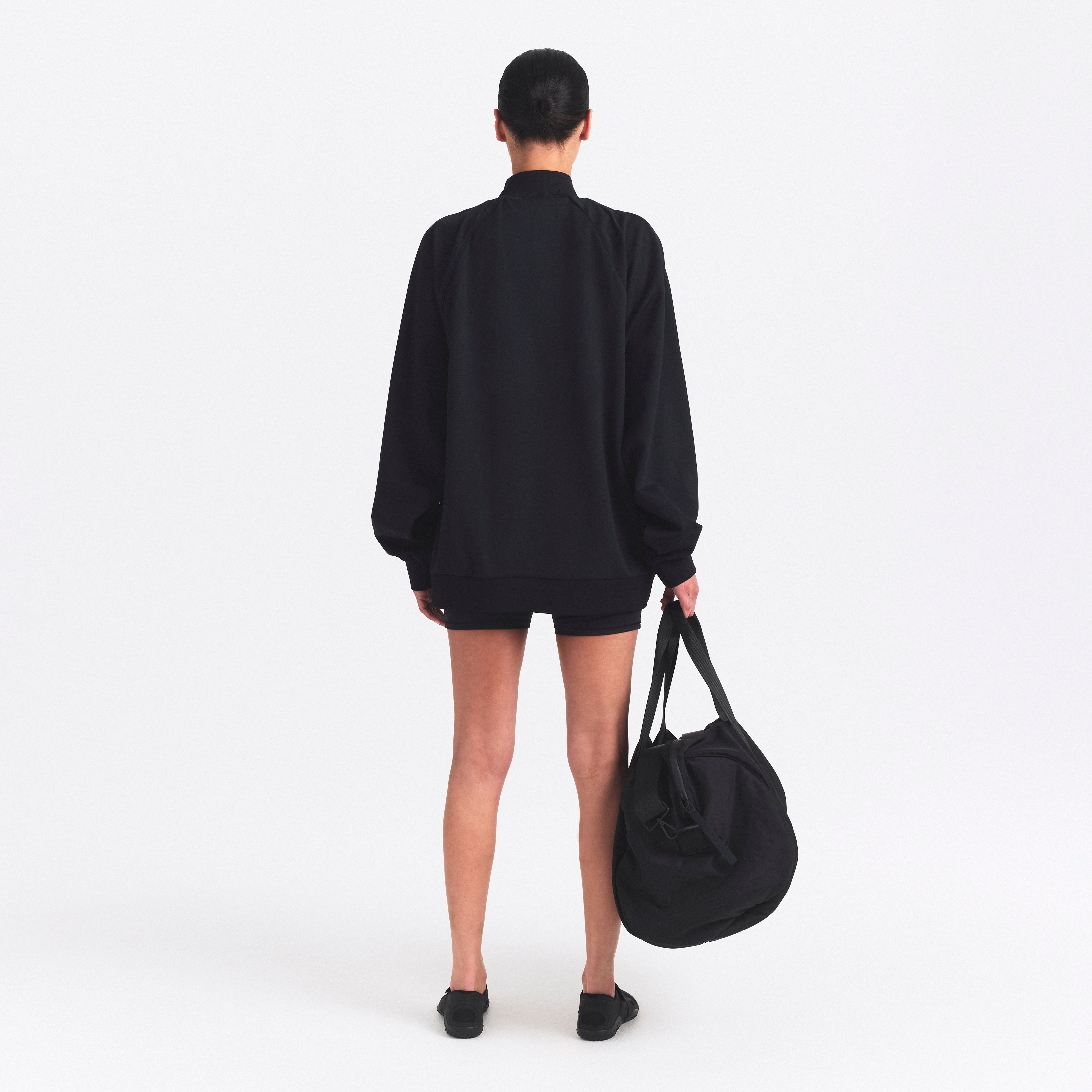 NikeSKIMS MATTE TRICOT OVERSIZED TRACK JACKET | OBSIDIAN ON A MODEL SIDE VIEW @ | FOCUS: 0.0, 1.0, 0.9