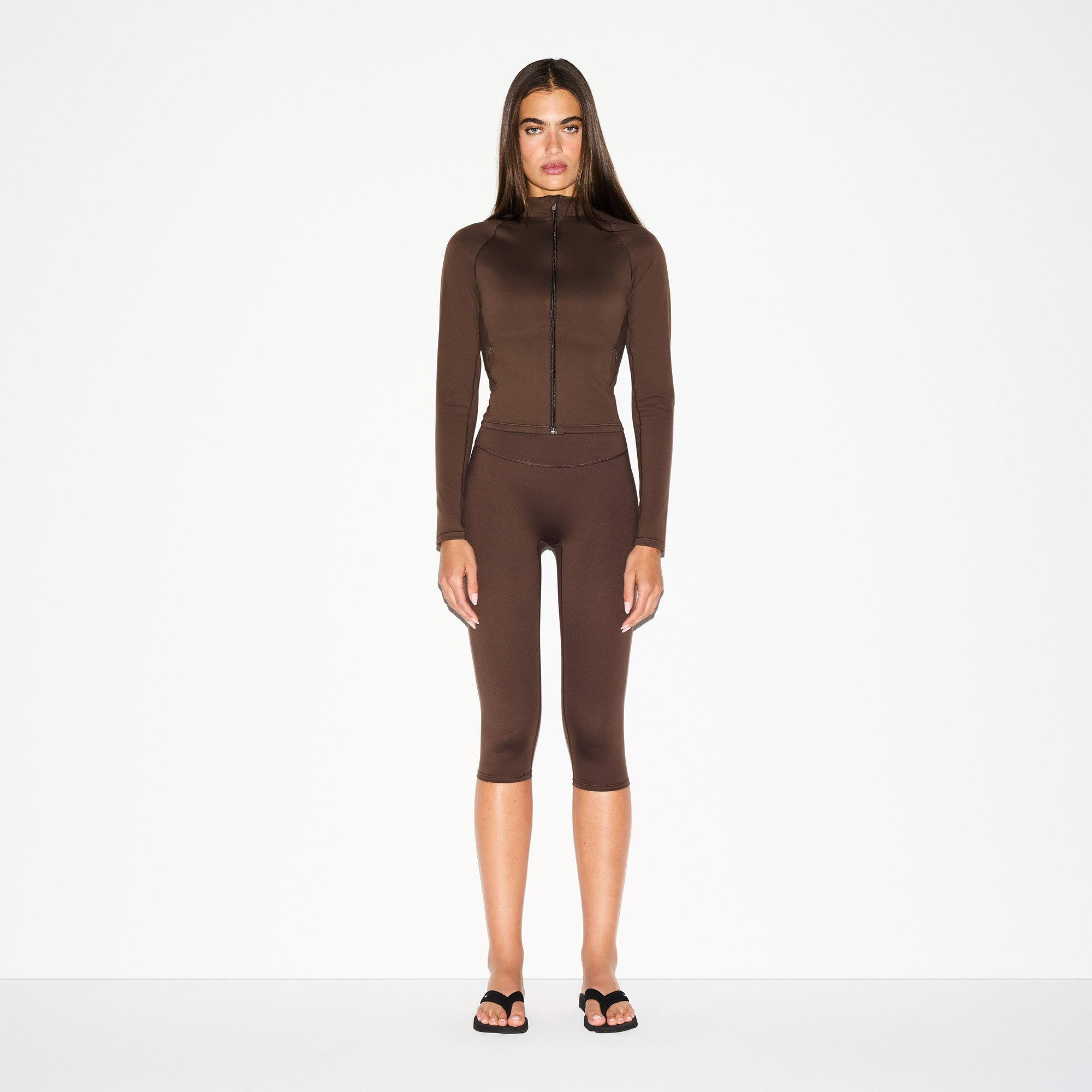 NikeSKIMS MATTE MOCK NECK FULL ZIP JACKET | DARK SEPIA ON A MODEL FRONT VIEW @ | FOCUS: 0.0, 1.0, 0.9