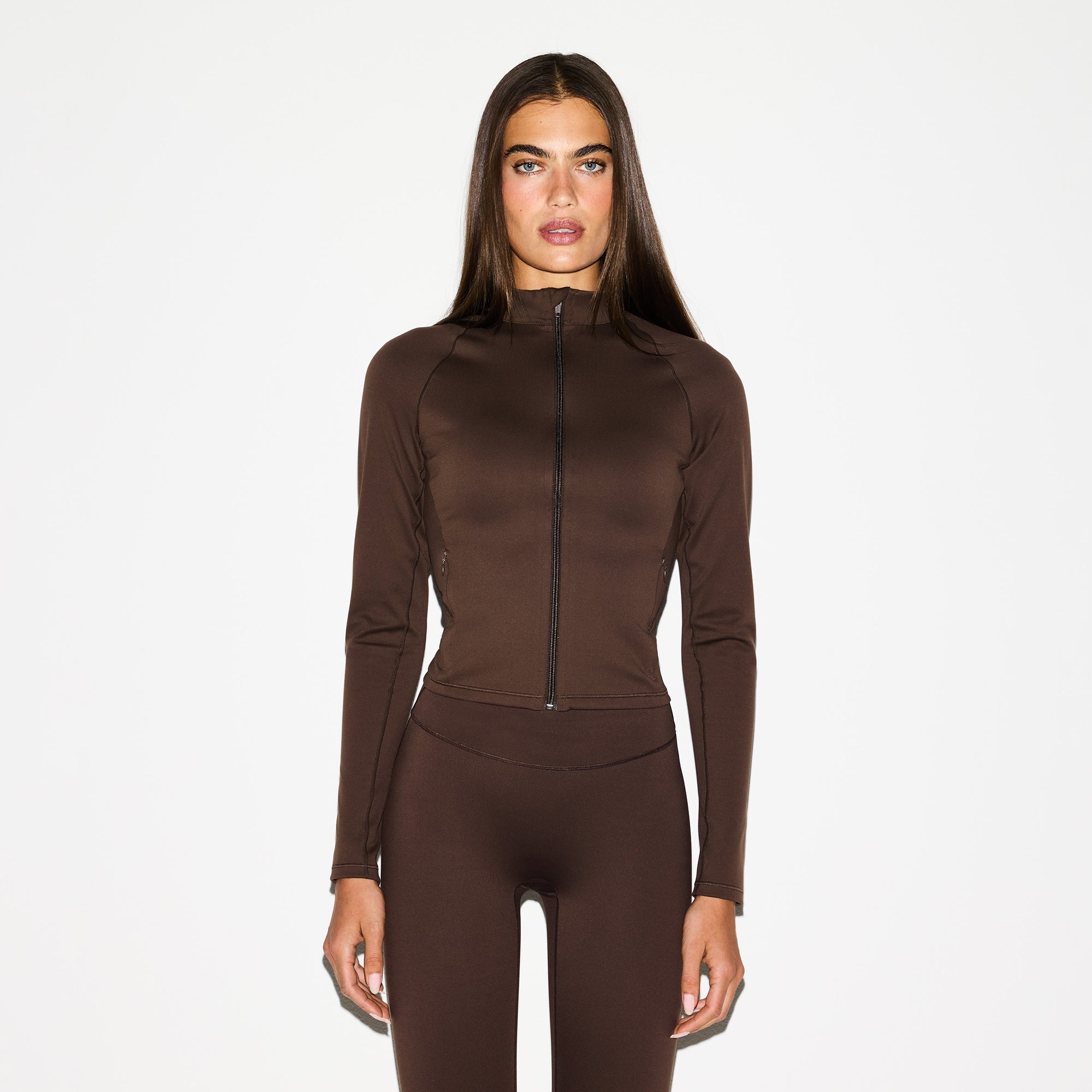 NikeSKIMS MATTE MOCK NECK FULL ZIP JACKET | DARK SEPIA ON A MODEL FRONT VIEW @ | FOCUS: 0.0, 1.0, 0.9
