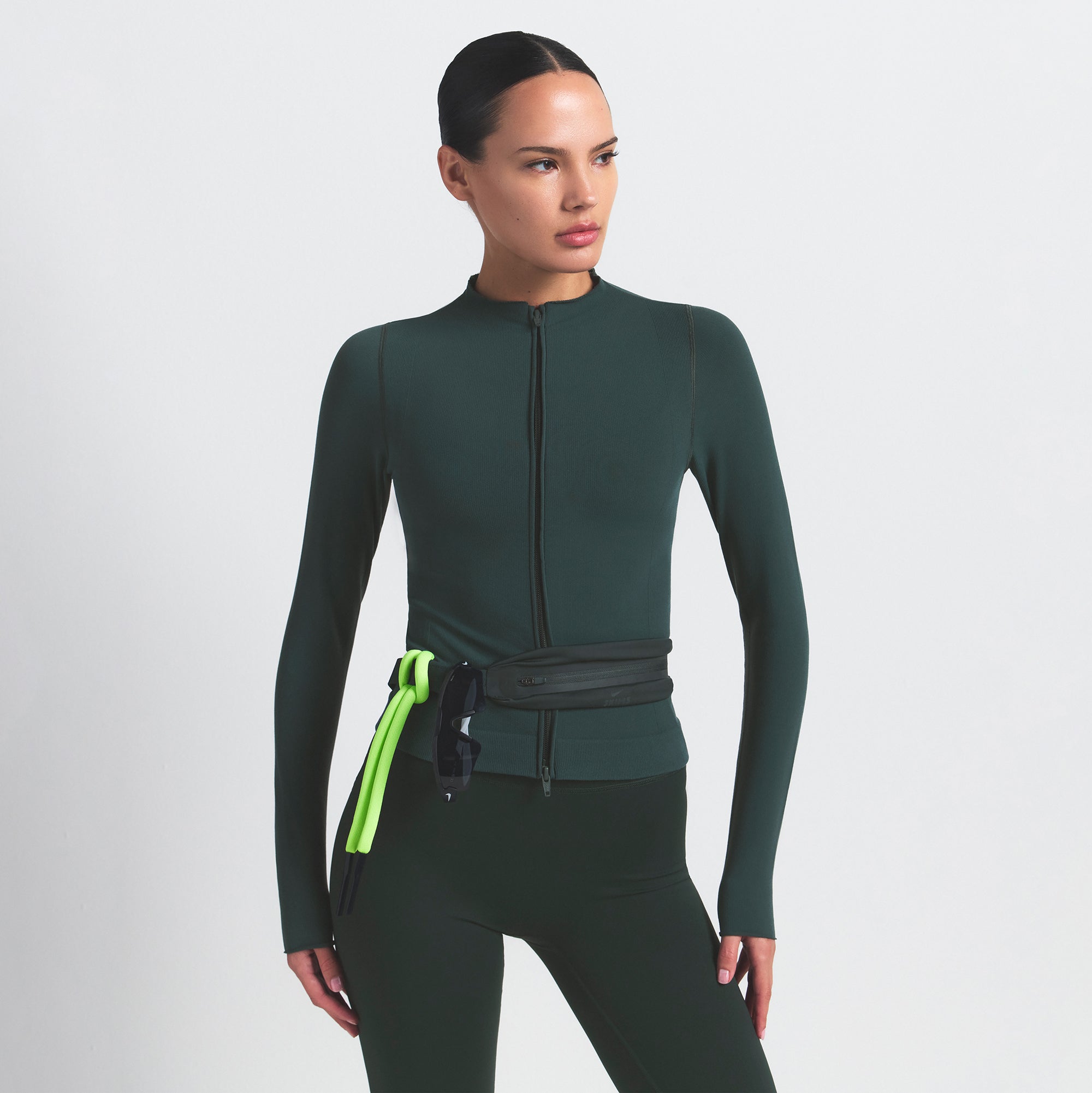 NikeSKIMS VINTAGE SEAMLESS FULL ZIP JACKET | DARK TEAL ON A MODEL SIDE VIEW @ | FOCUS: 0.0, 1.0, 0.9