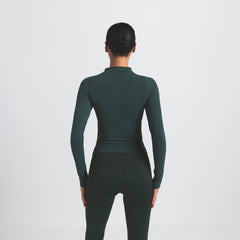 NikeSKIMS VINTAGE SEAMLESS FULL ZIP JACKET | DARK TEAL ON A MODEL SIDE VIEW @ | FOCUS: 0.0, 1.0, 0.9